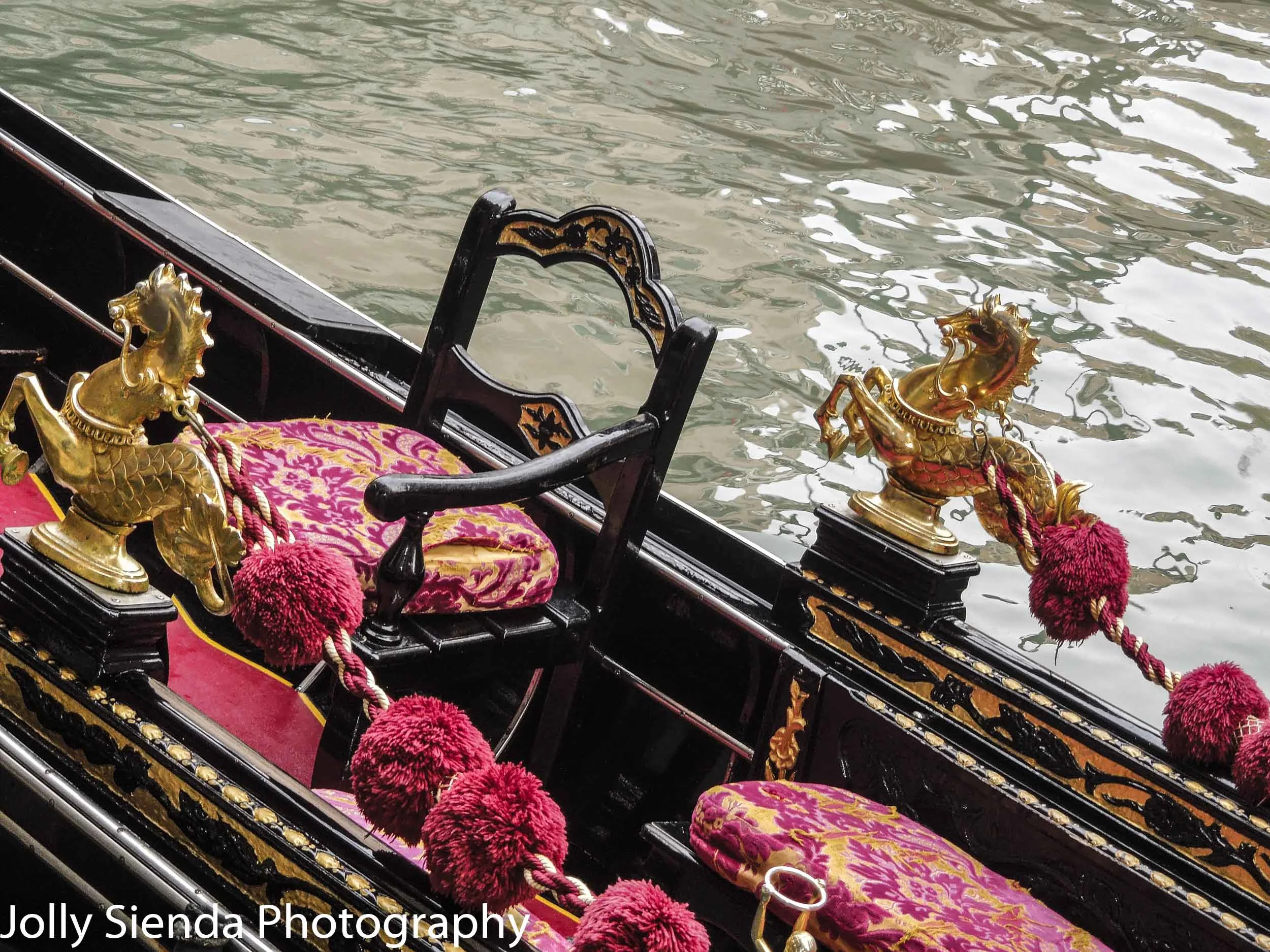 Gondola interior adorned with a golden horse serpent,  velveteen