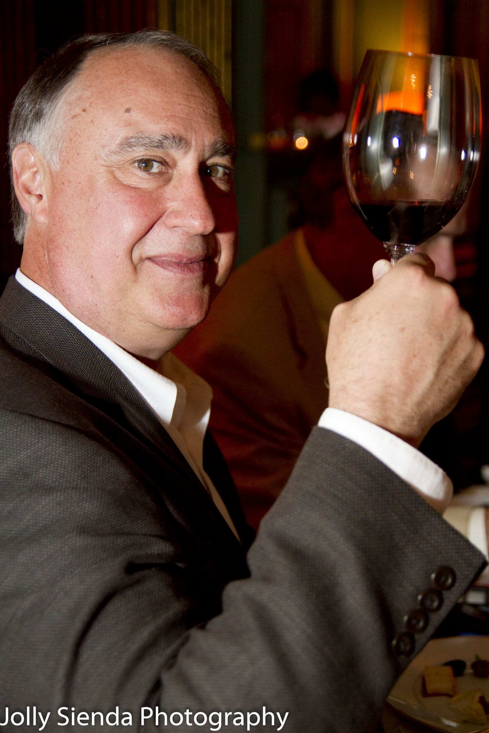 Portrait of a man making a toast with a glass of wine