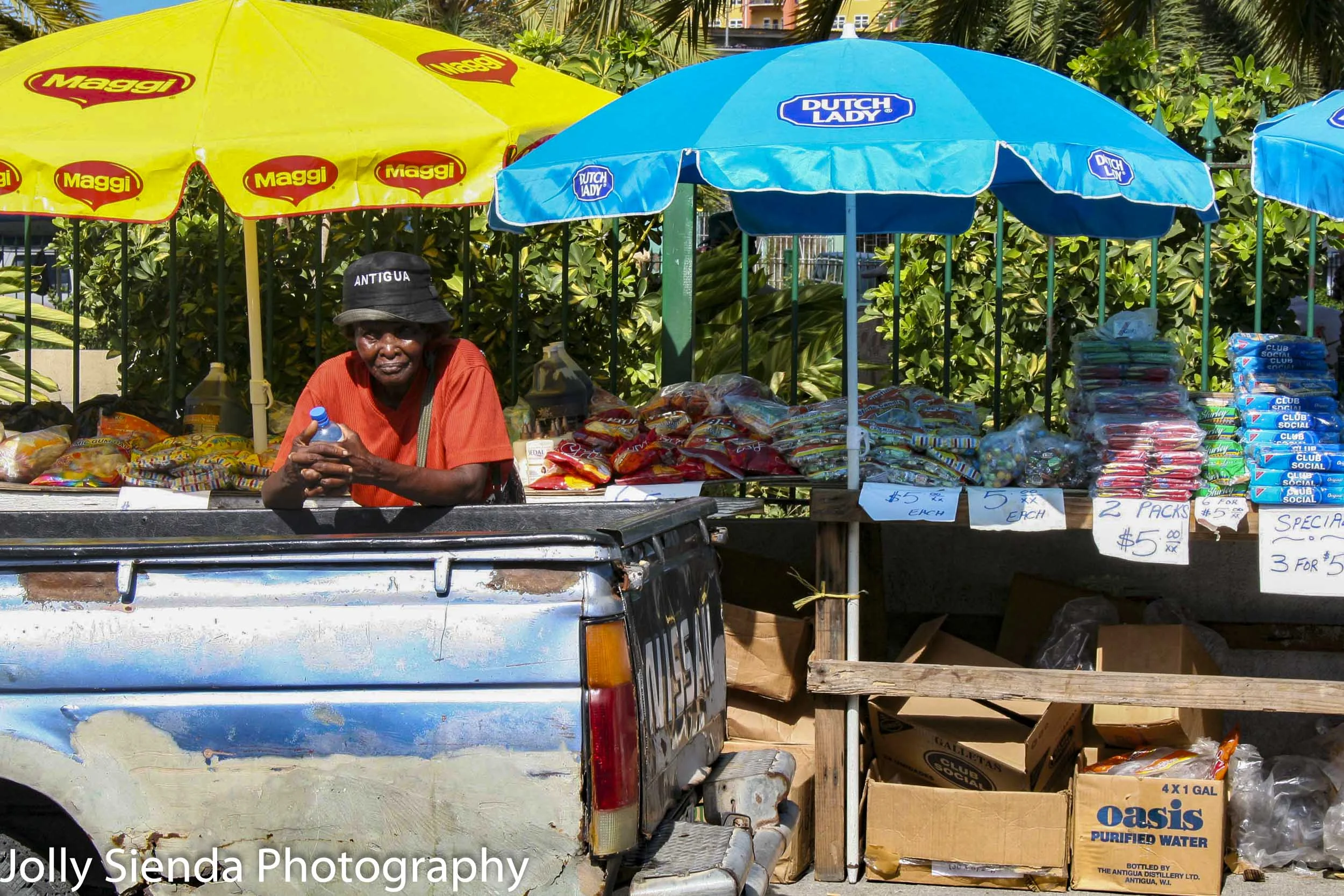 Woman pauses selling products at a street market
