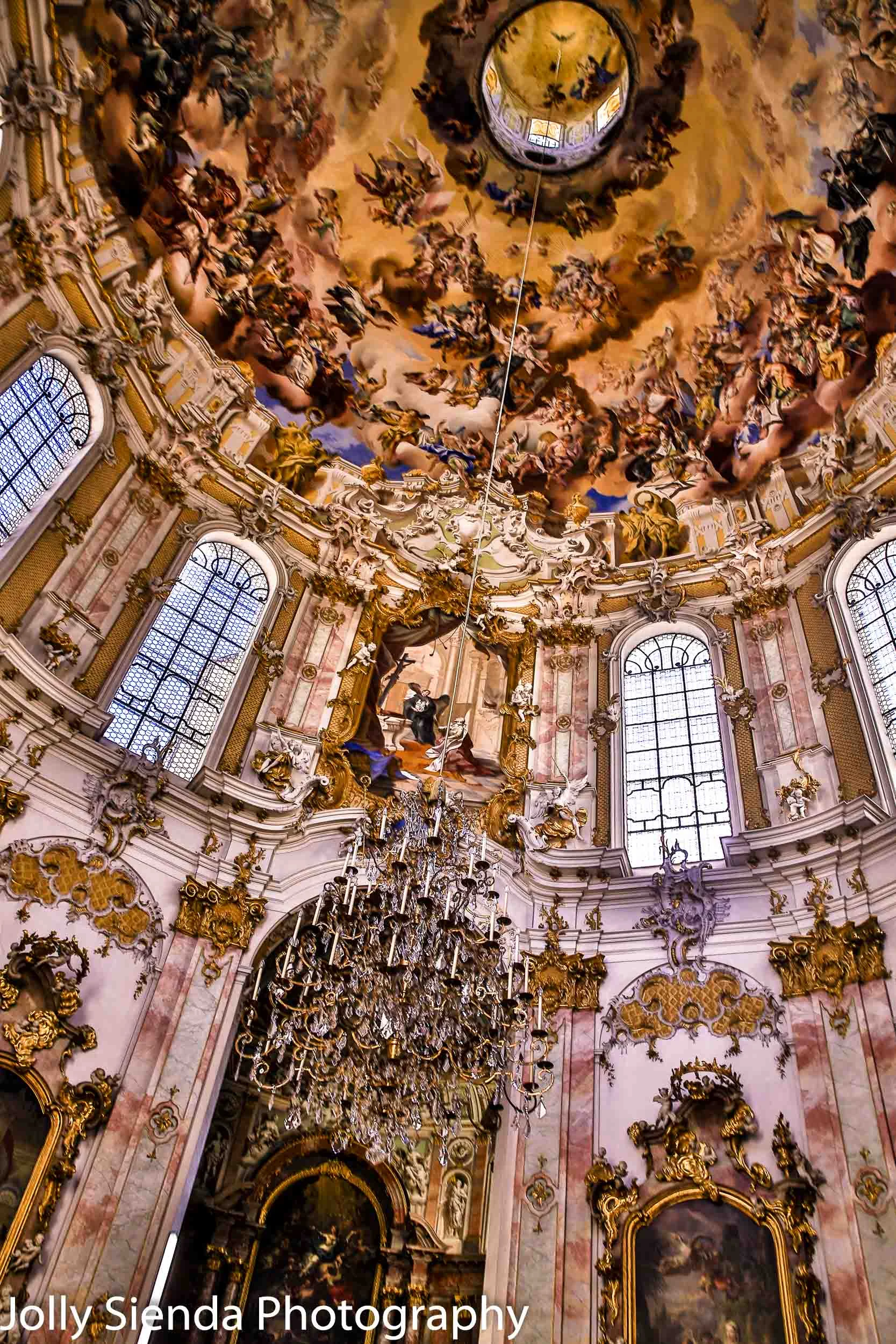 Interior of the Ettal Monastery dome; a chandelier, paintings, r