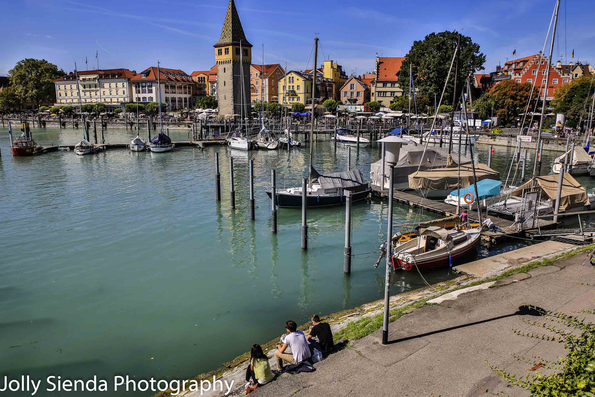 Lindau am Bodensee marina, boats, and people sitting on the bank