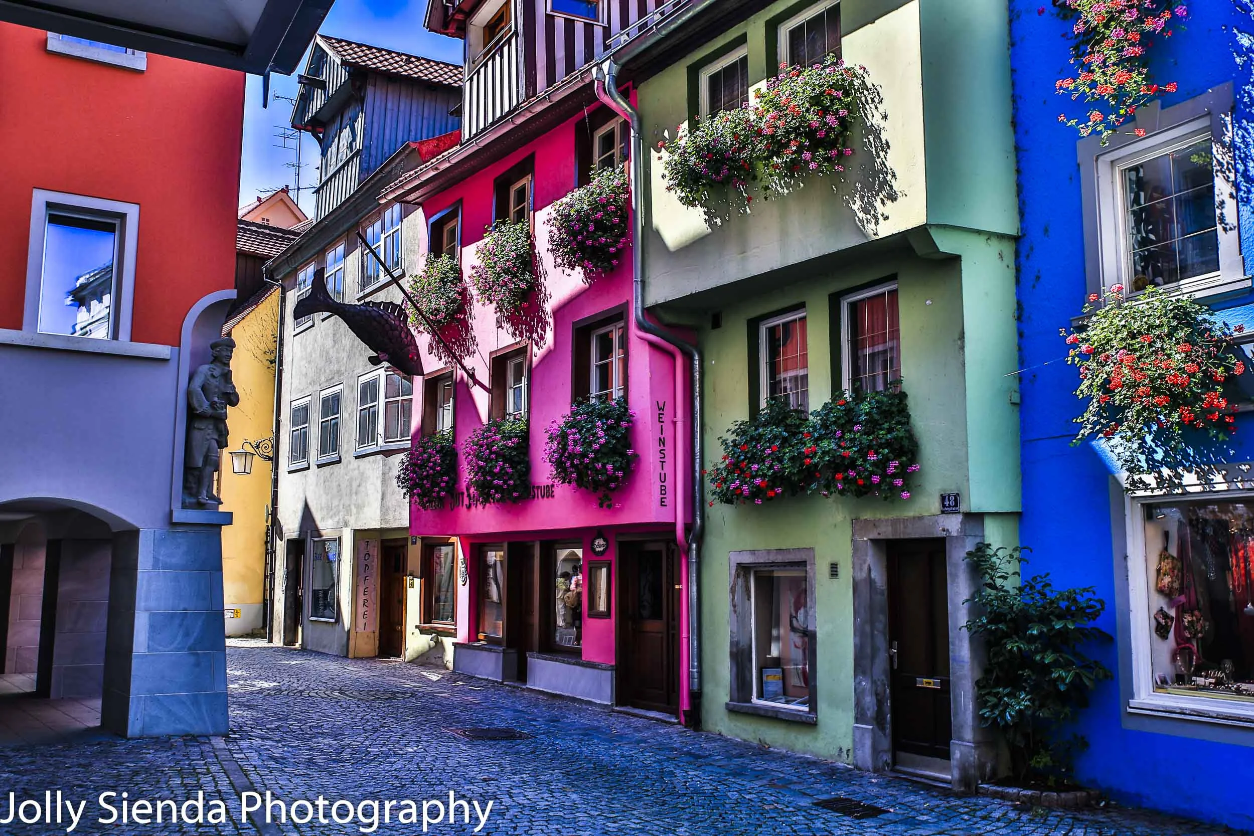 Pastel colored painted village with blooming flower window boxes
