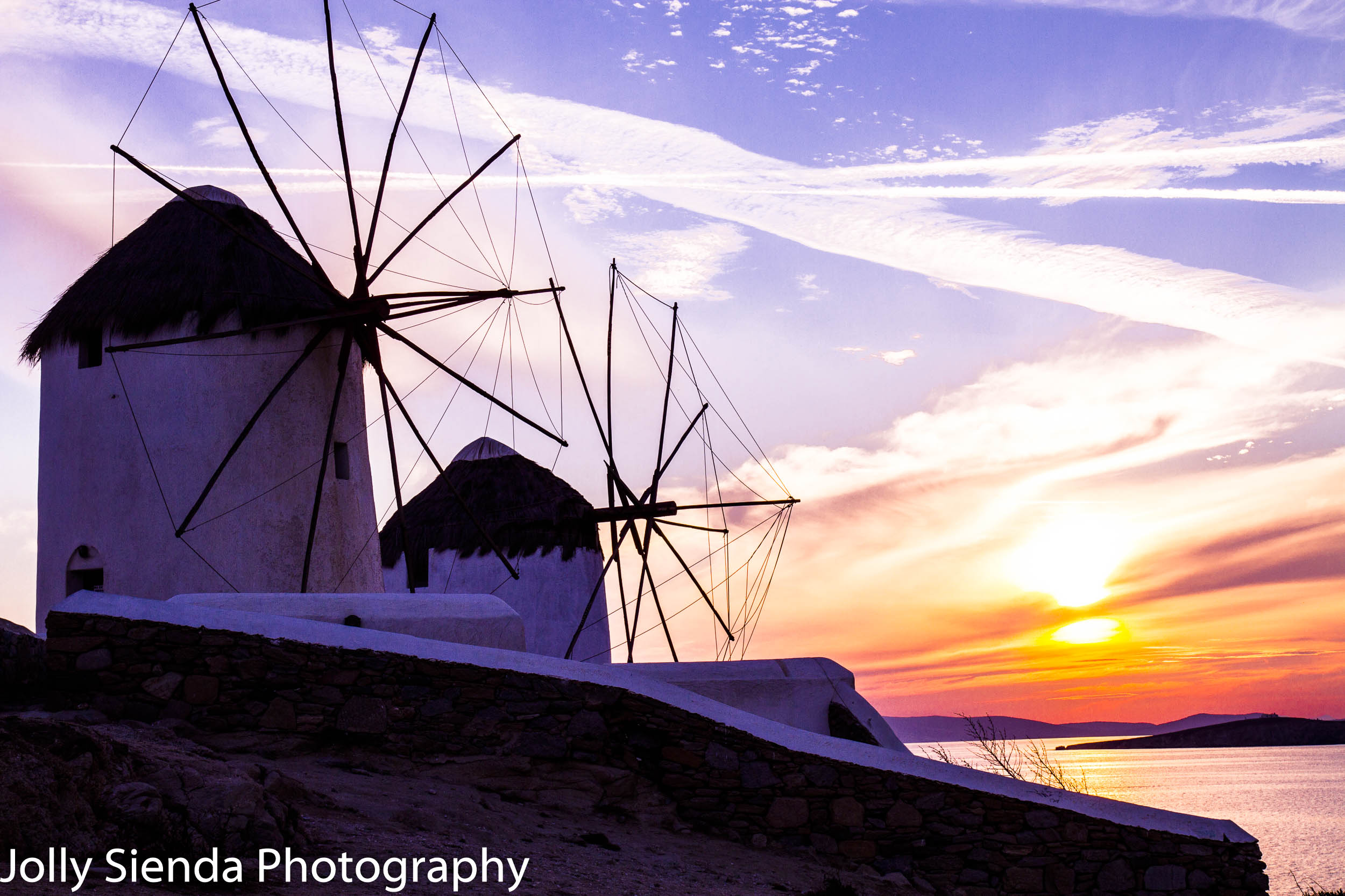 Two Windmills bask in golden pink sunset 