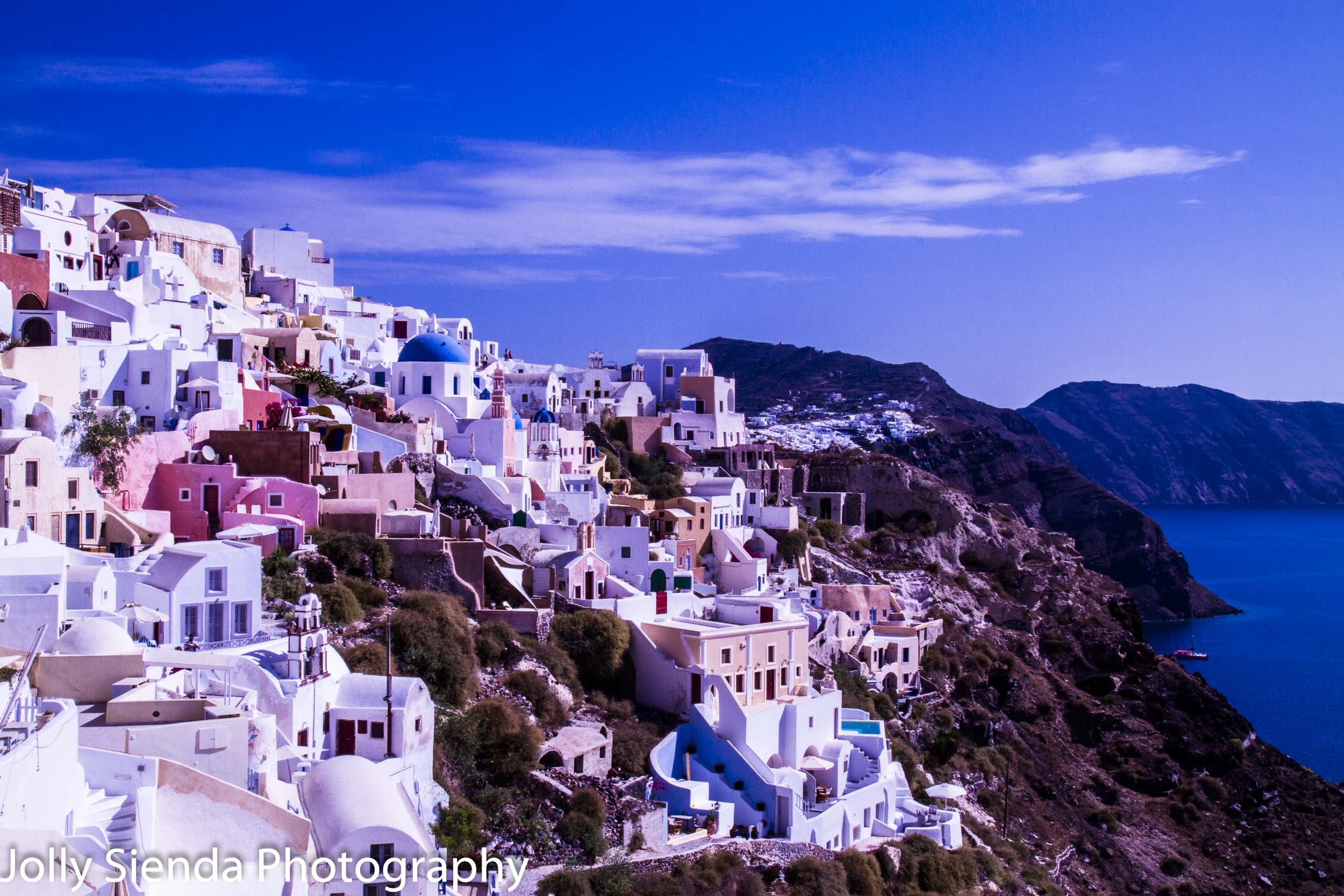 Oia, white washed and blue, sits over Caldera