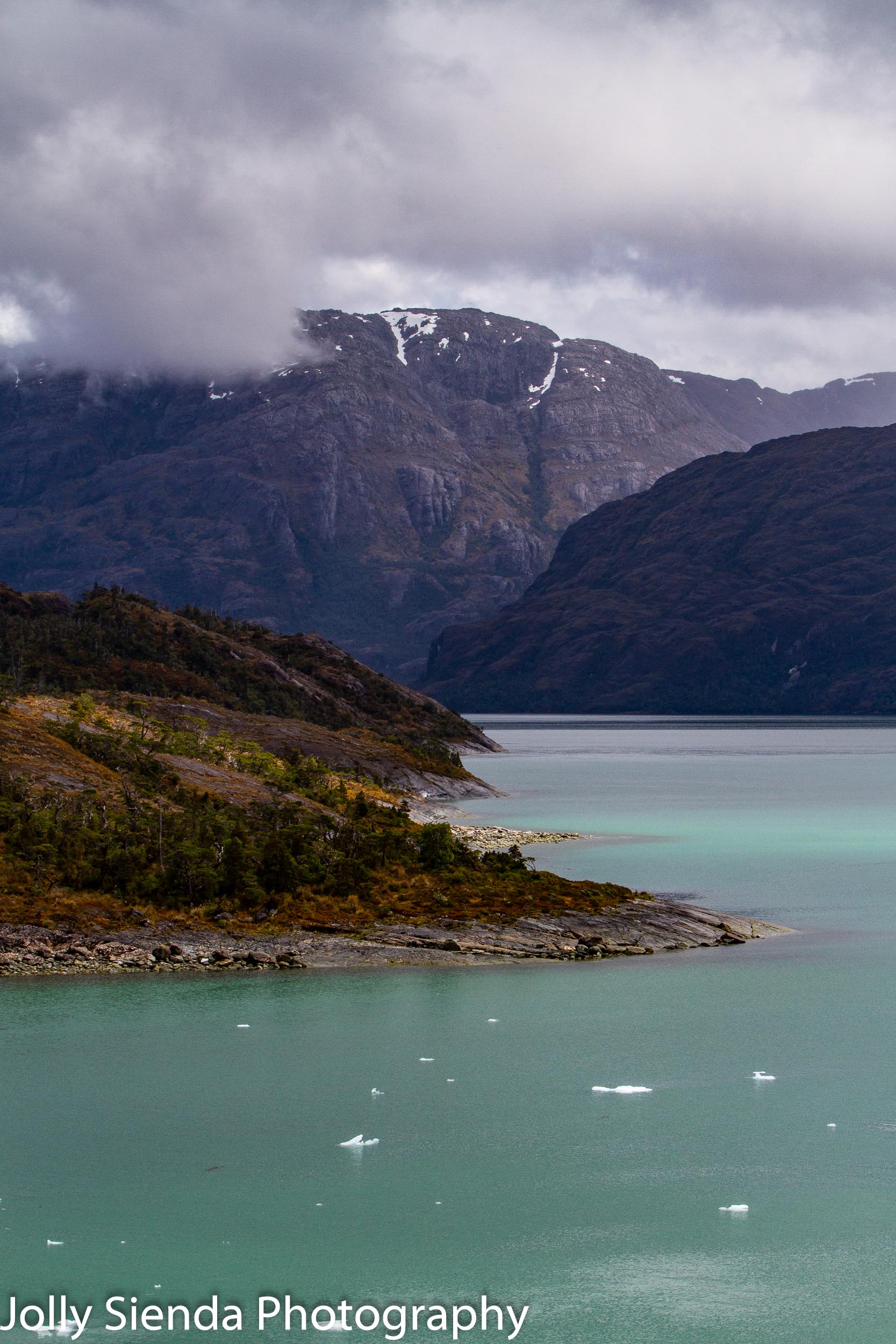 Icebergs float on blue green Chilean Fjord water