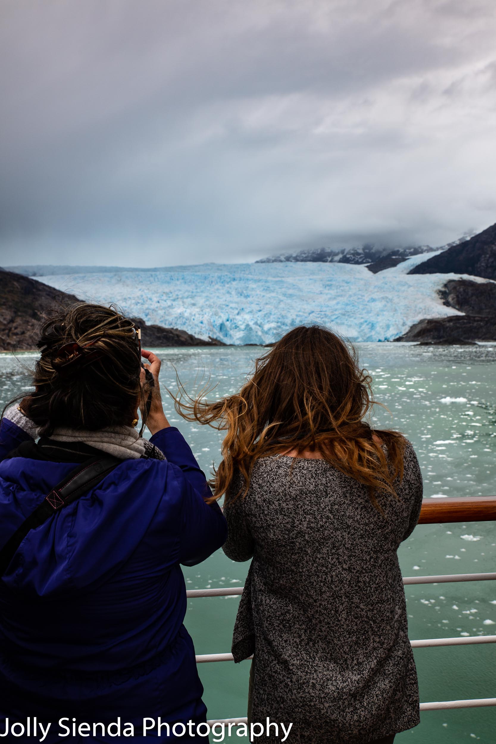 Tourists take pictures of the Brujo Glacier