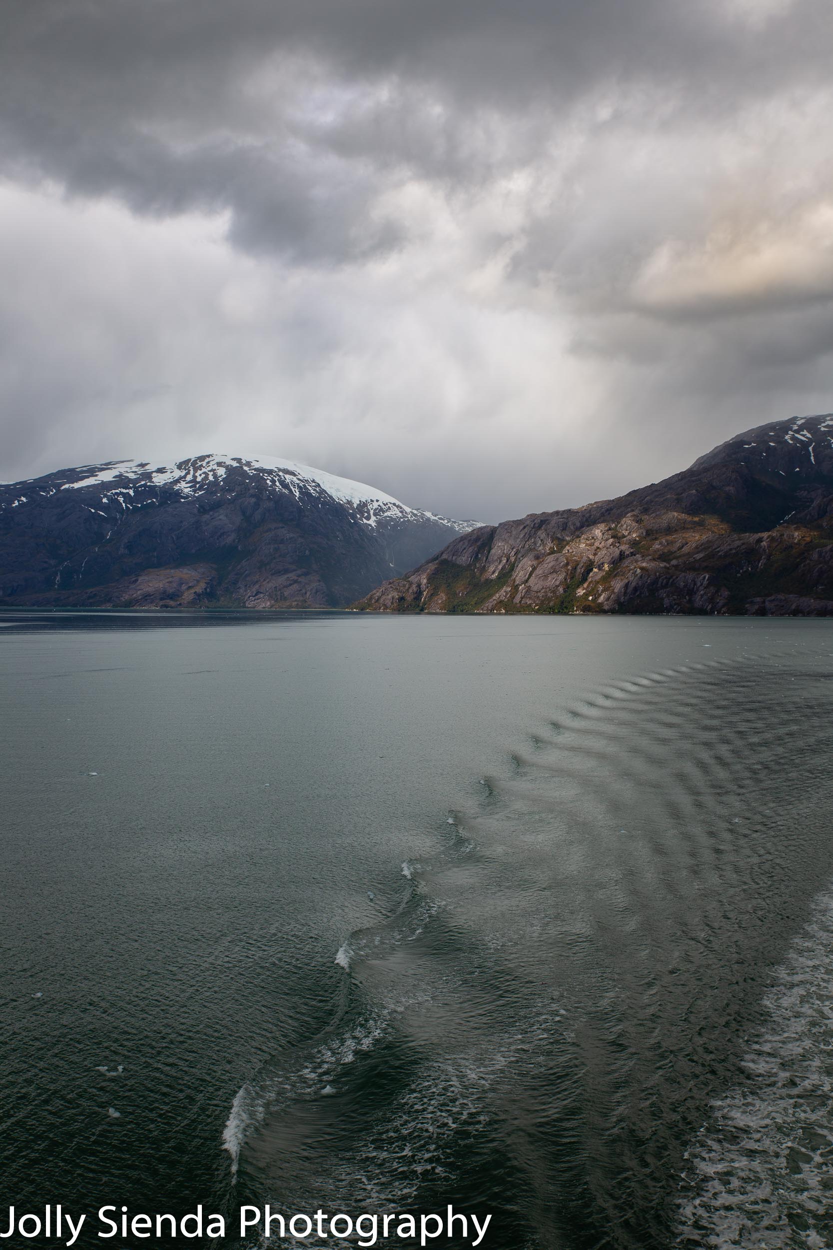 Long water ripple and the snow capped Chilean Fjords