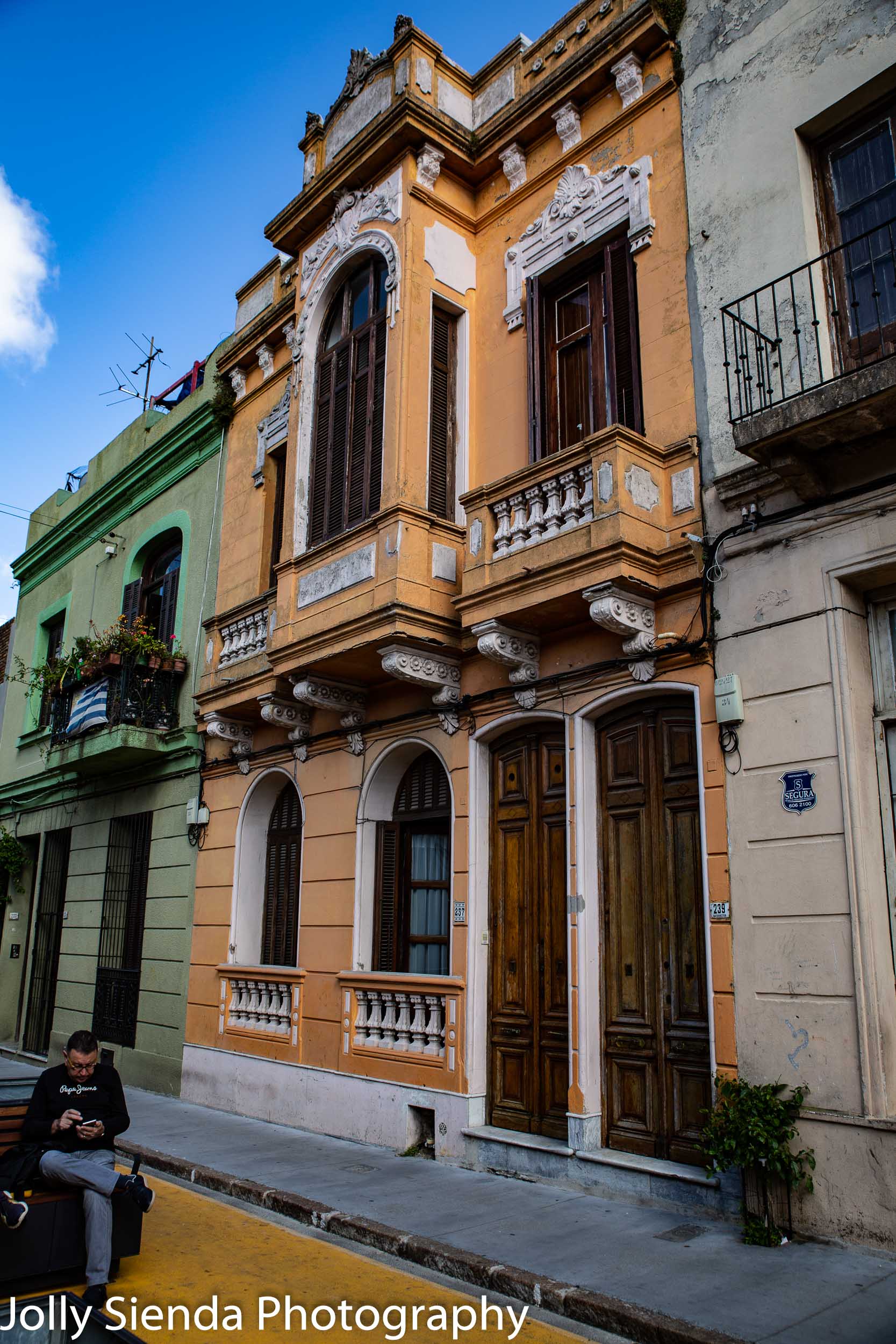 Colonial Spanish architecture, blanconies, and a man checking hi