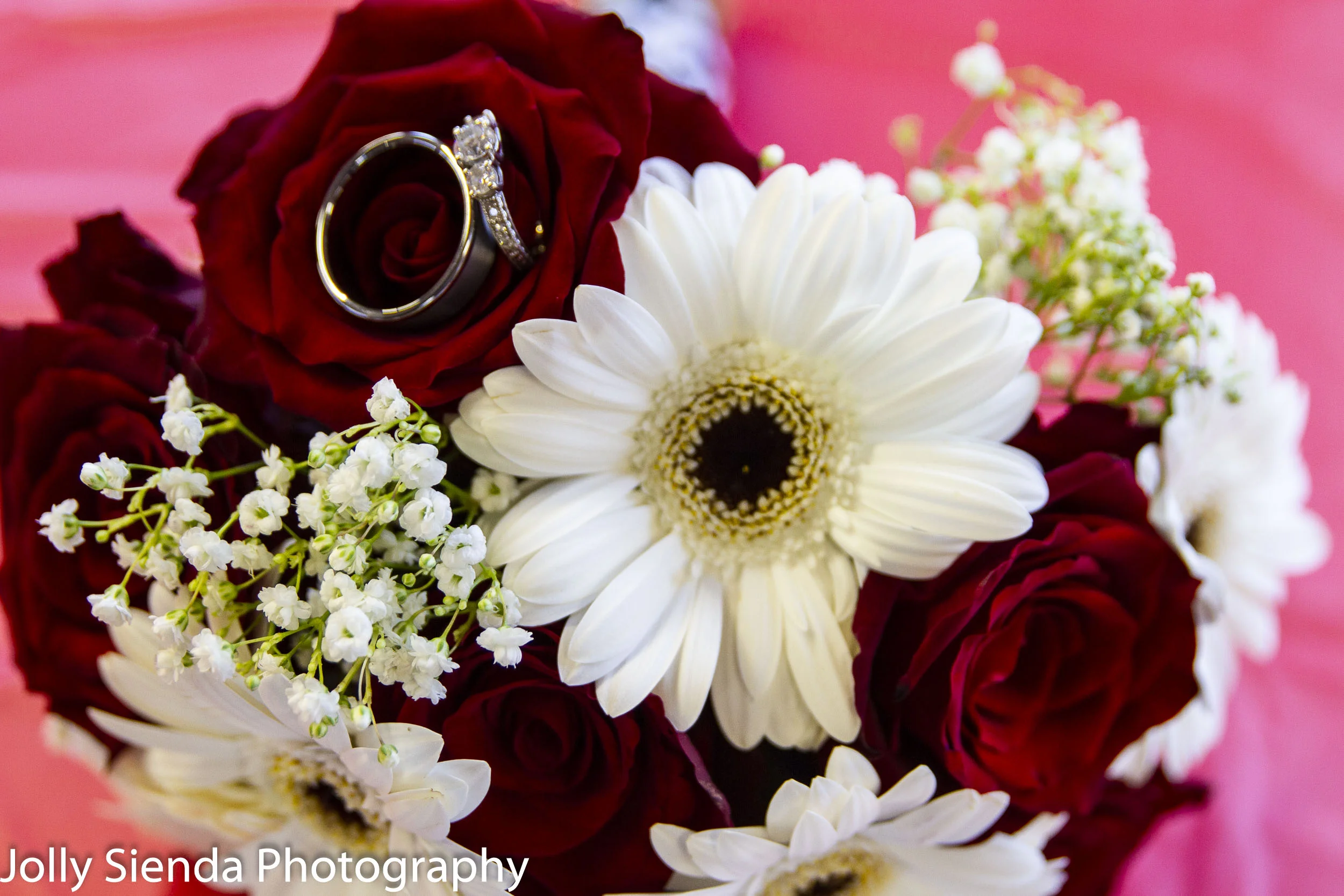Bride and groom wedding rings in the brides bouquet