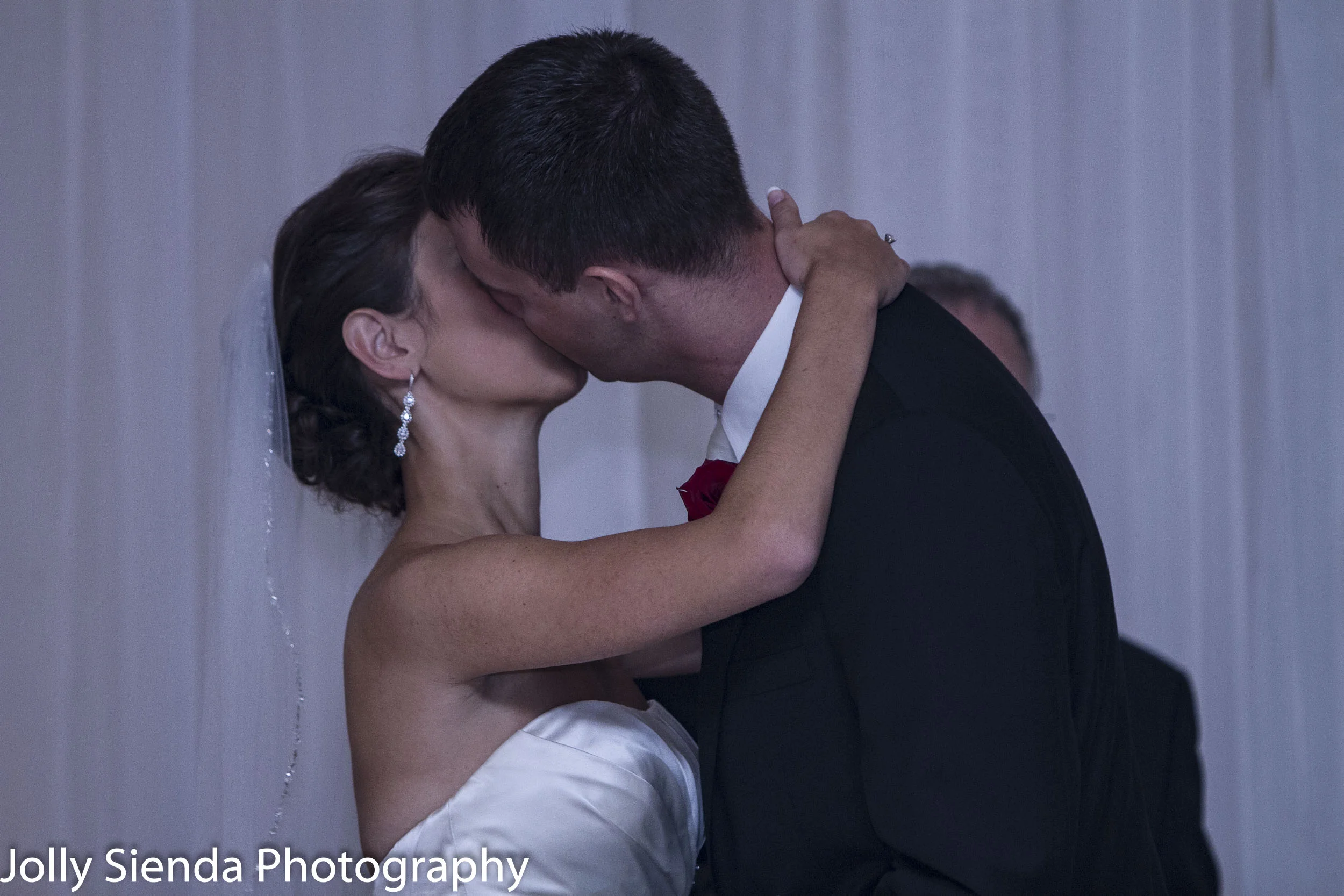 The bride and groom share their first kiss as man and wife at their wedding ceremony.