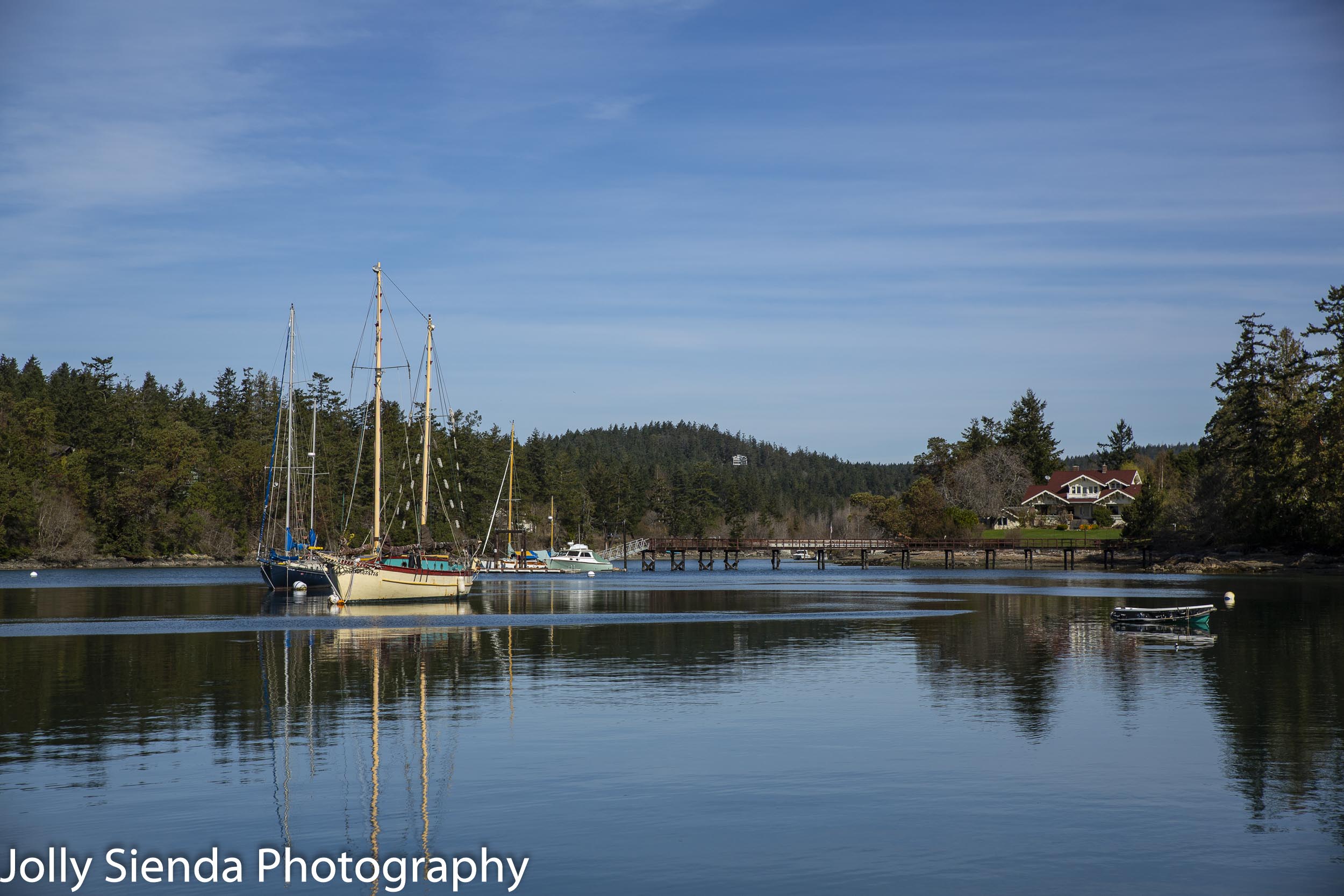 Calm on the water inlet with boats and sailboats