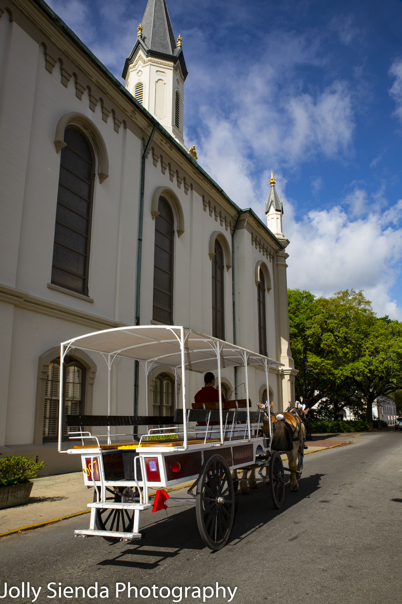 Horse drawn carriage and antebellum church