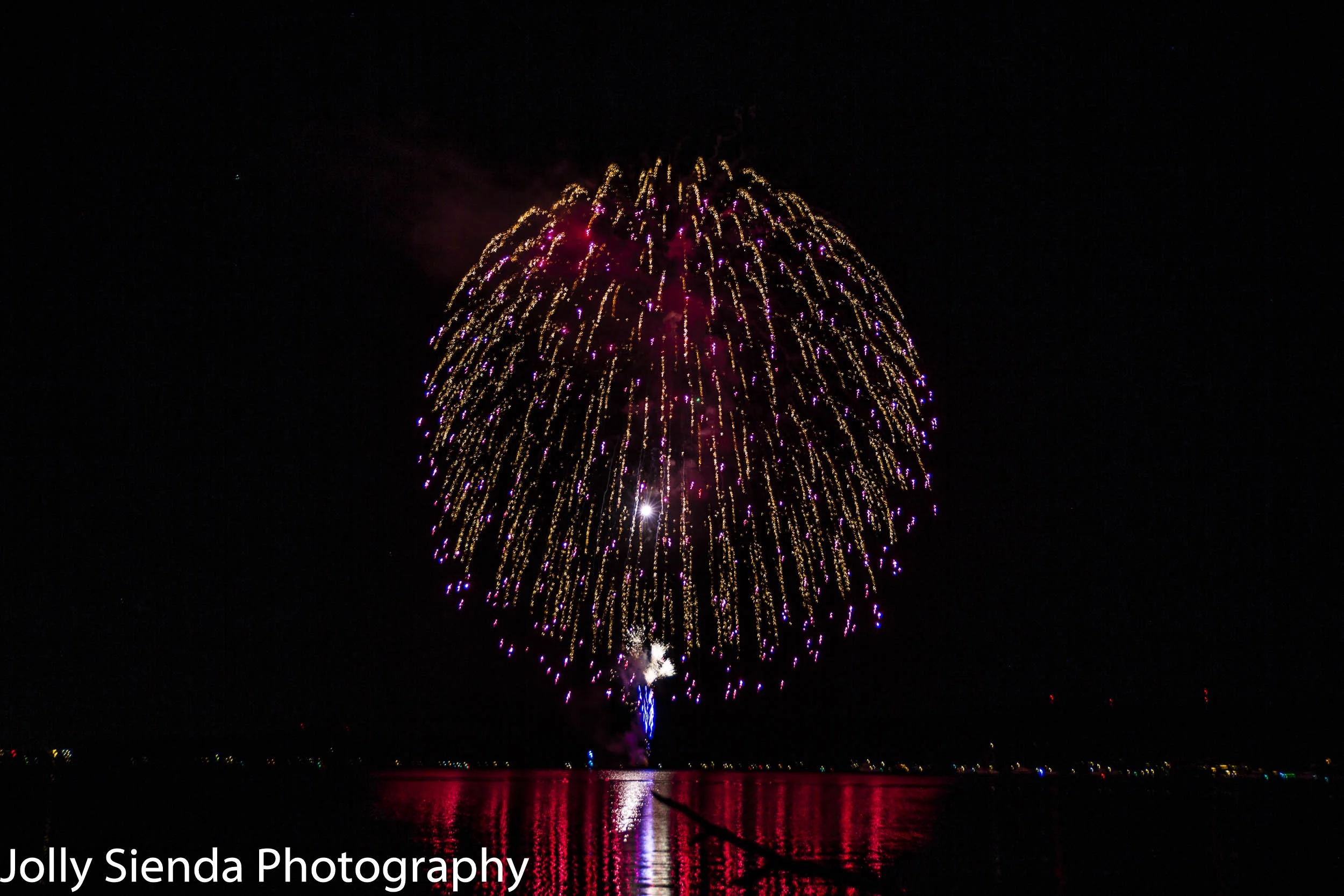Long fireworks burst over Dyes Inlet, Silverdale, WA.