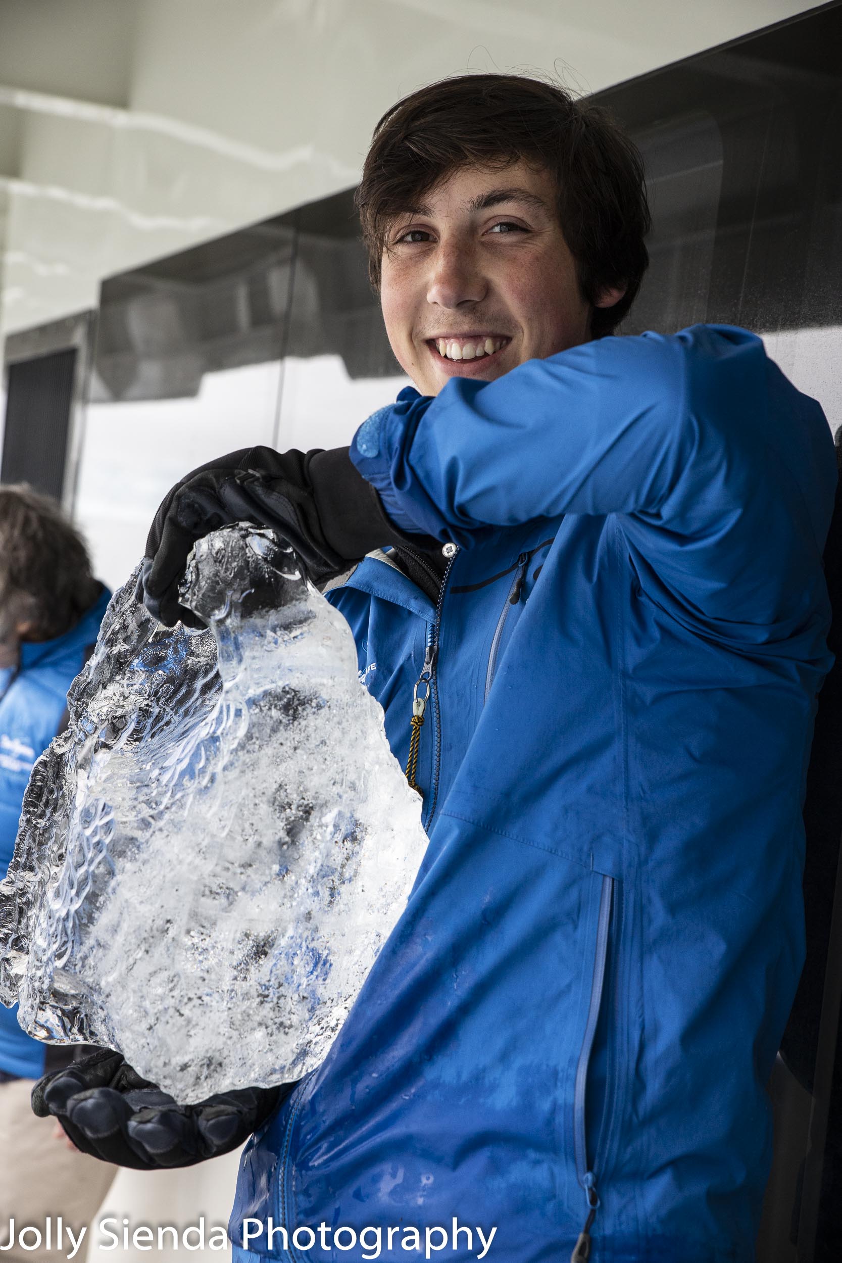 Person holding a bock of artic ice