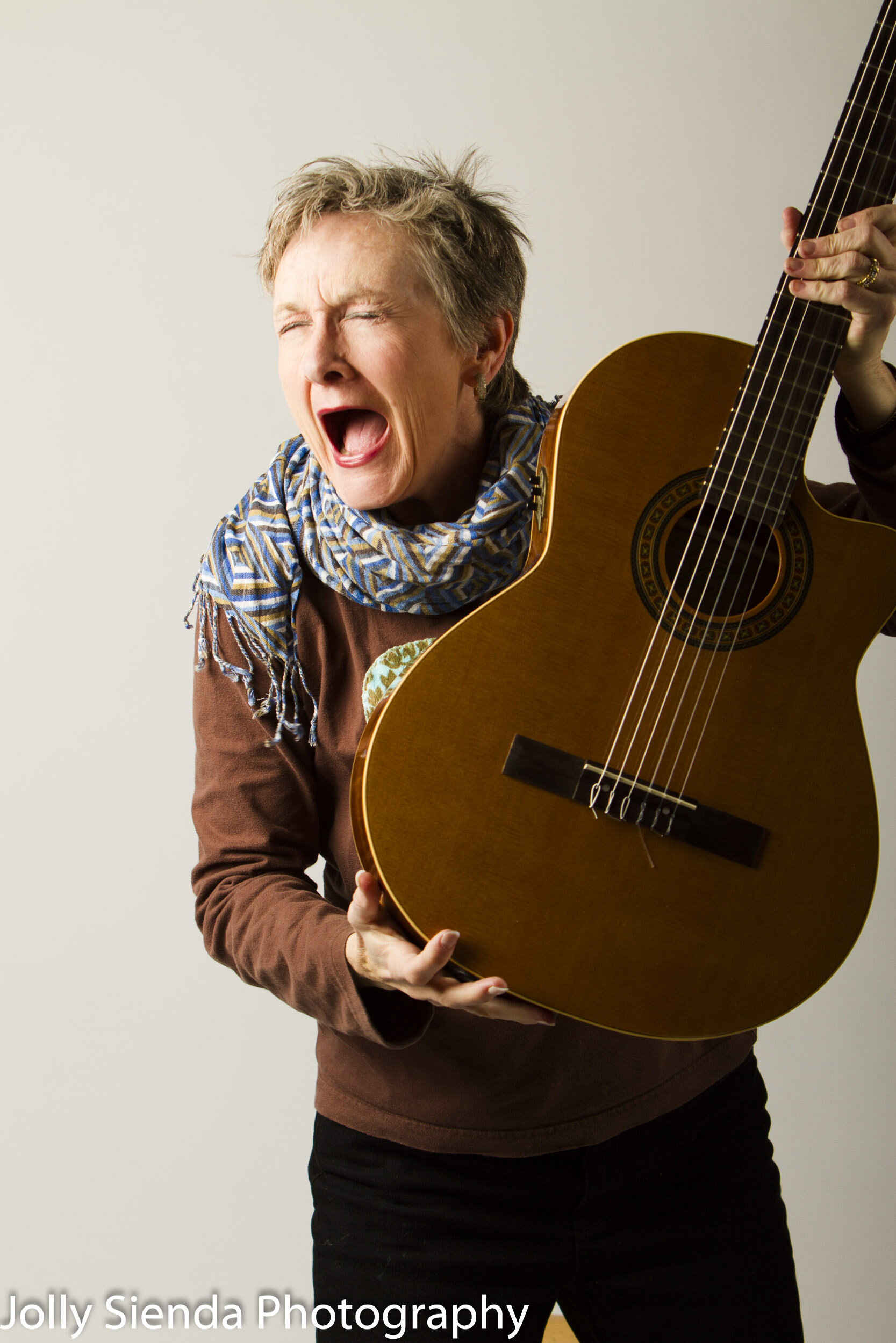 Studio portrait of a female guitar musician