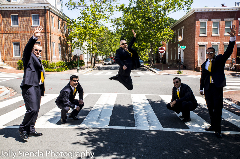 Portrait of a groom and his best men jumping in the street