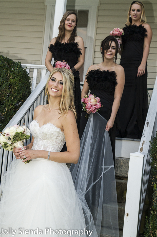 Portrait of a bride and her bridesmaids posing on steps