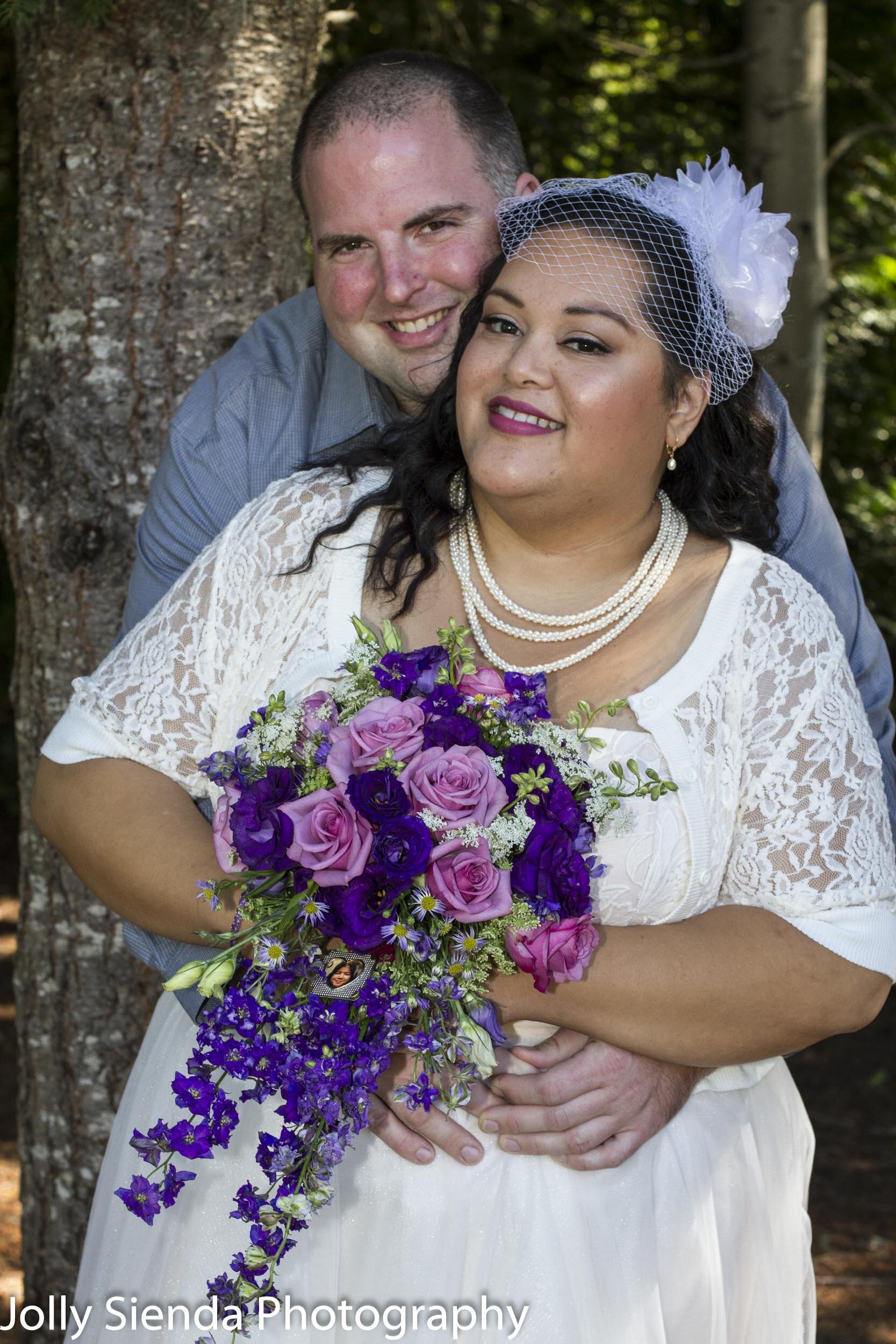 Bride and groom wedding portrait, in the forest, with bouquet