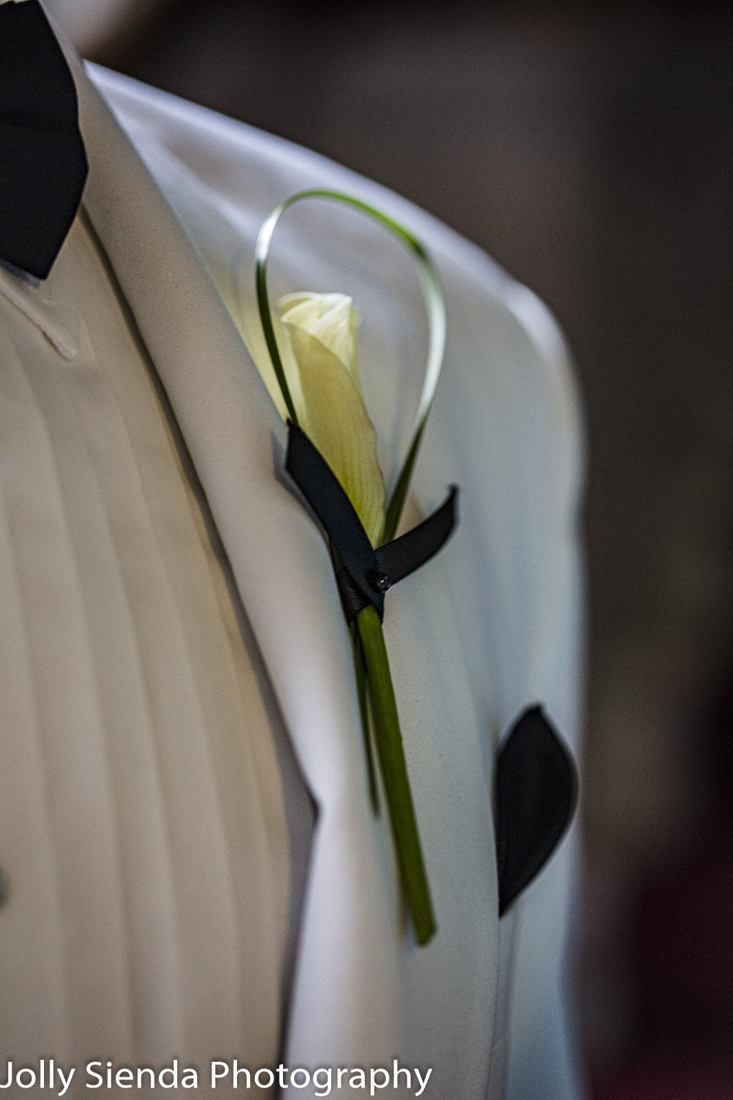 Grooms white tux wedding boutonniere attire