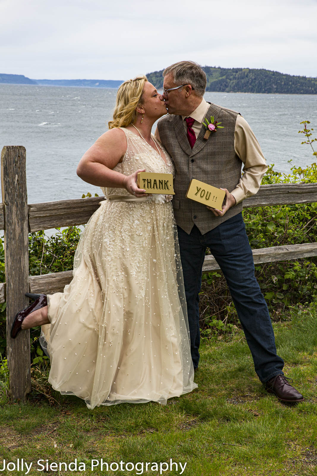 Bride and groom kiss and thank you wedding photography