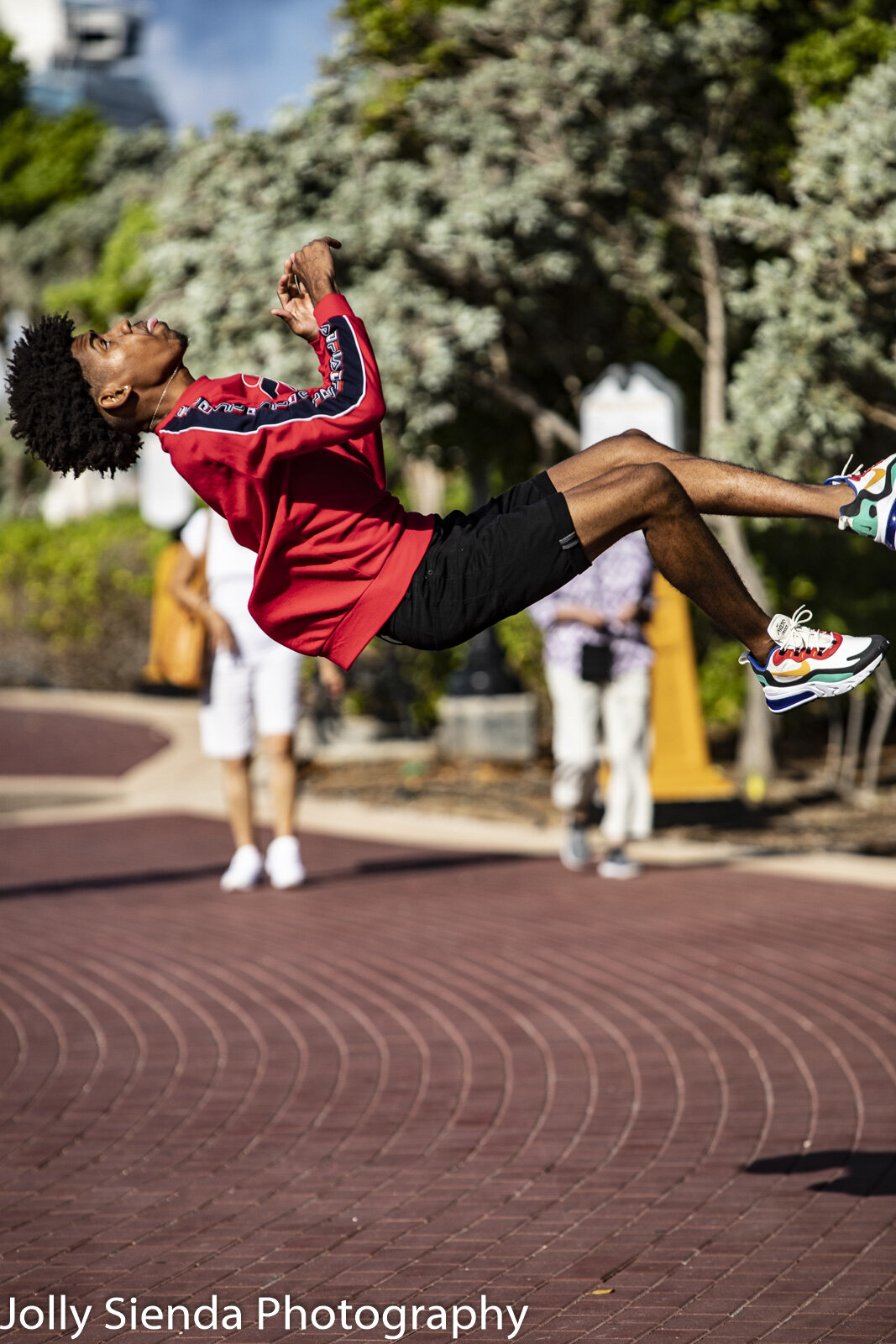 Teenage boy does a sommersault in mid air