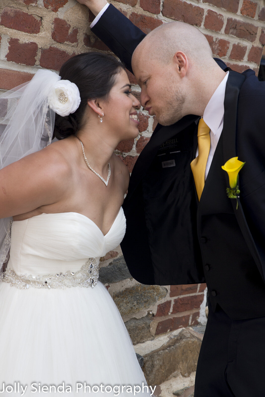 Urban portrait of a bride an groom going in for a kiss