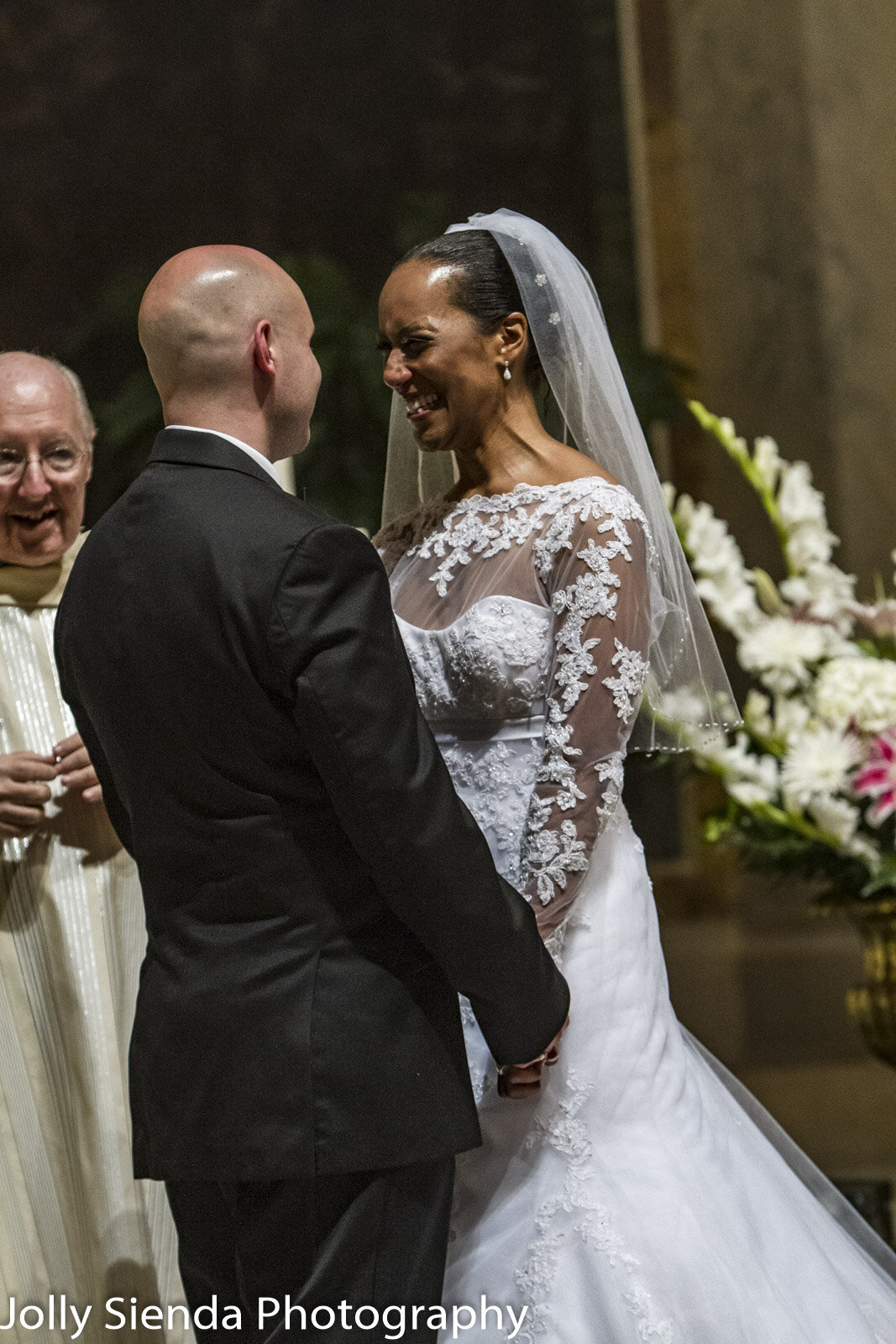 Bride and groom laugh at the alter wedding photography