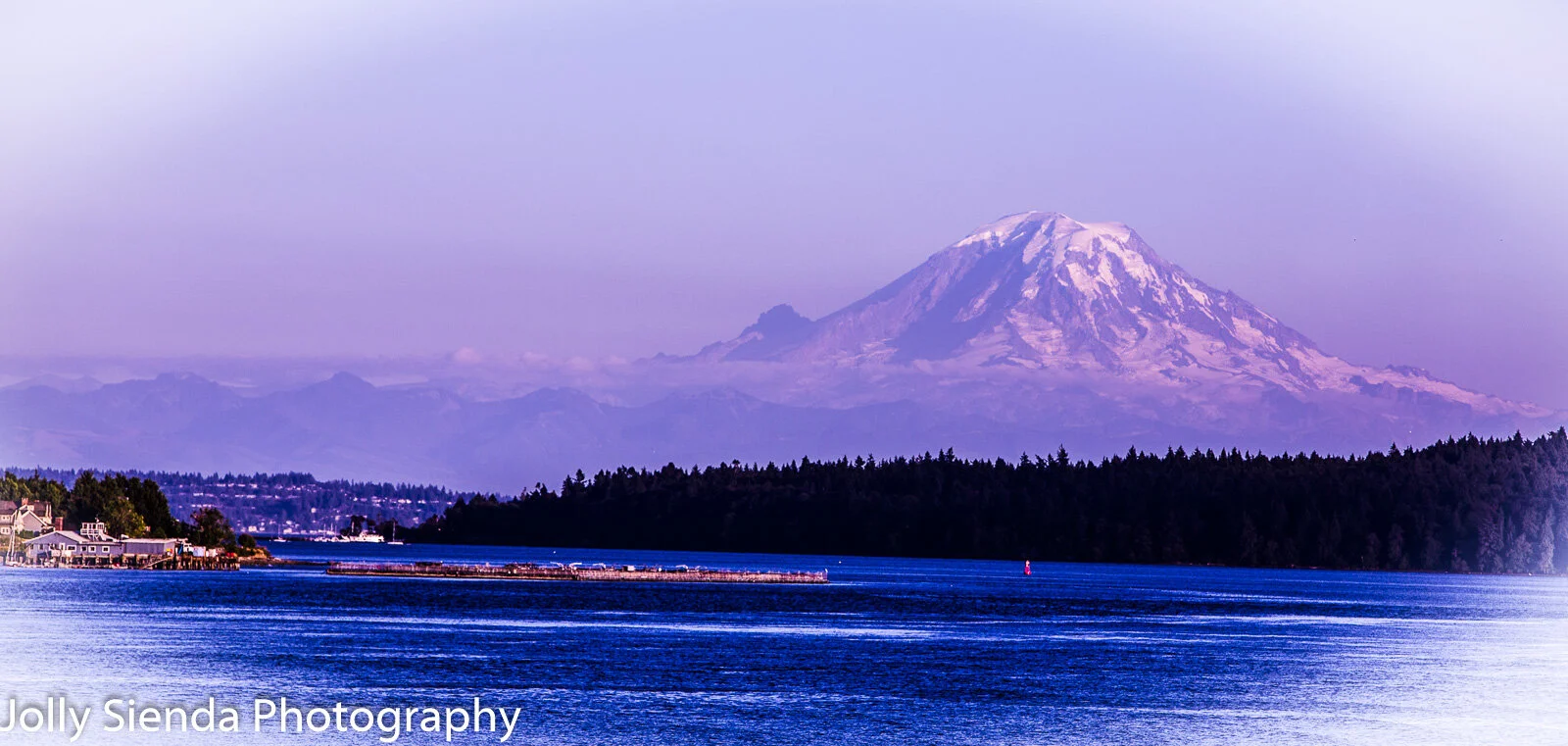 Mount Rainier at dusk towers over the Puget Sound during a pink  (Copy)