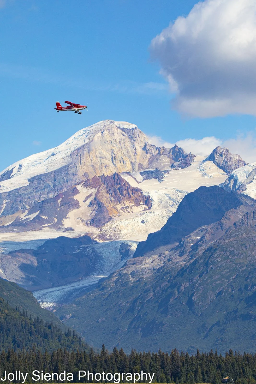Fly in Alaska in a red plane over a glacier