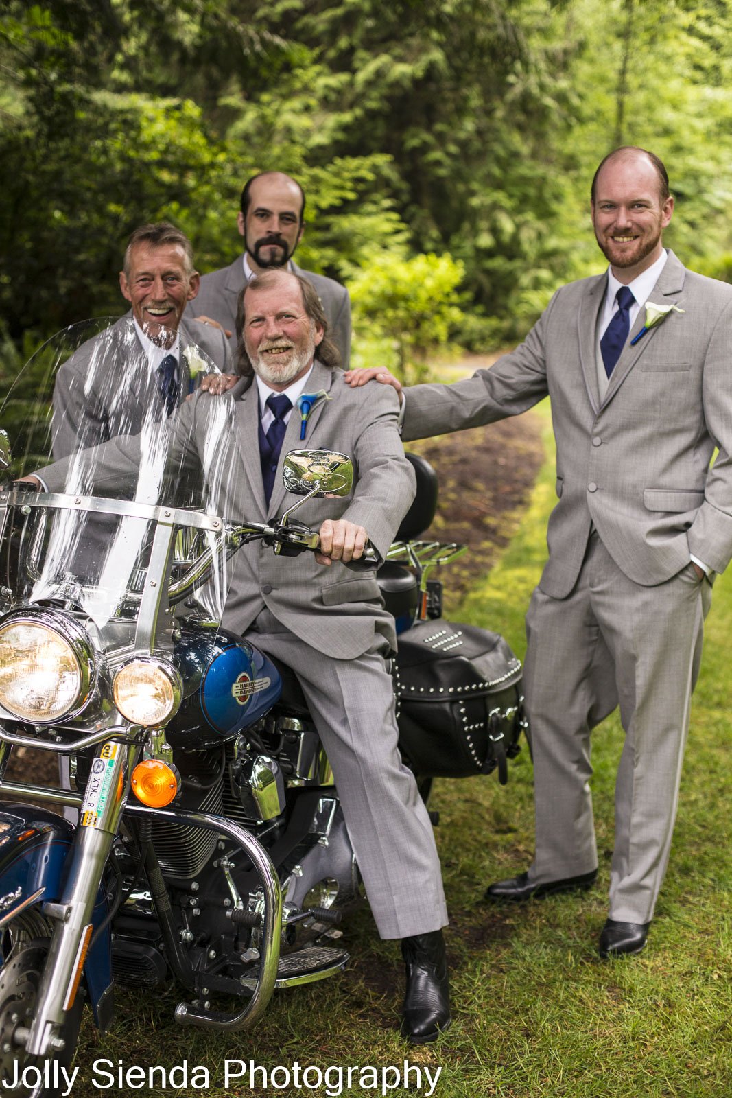 Groom and groomsmen at a wedding with their motorcycle