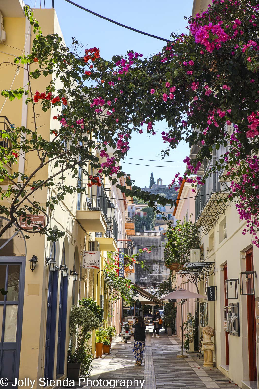 Mediterranean village of Napflion, Greece and pink bougainvilla 