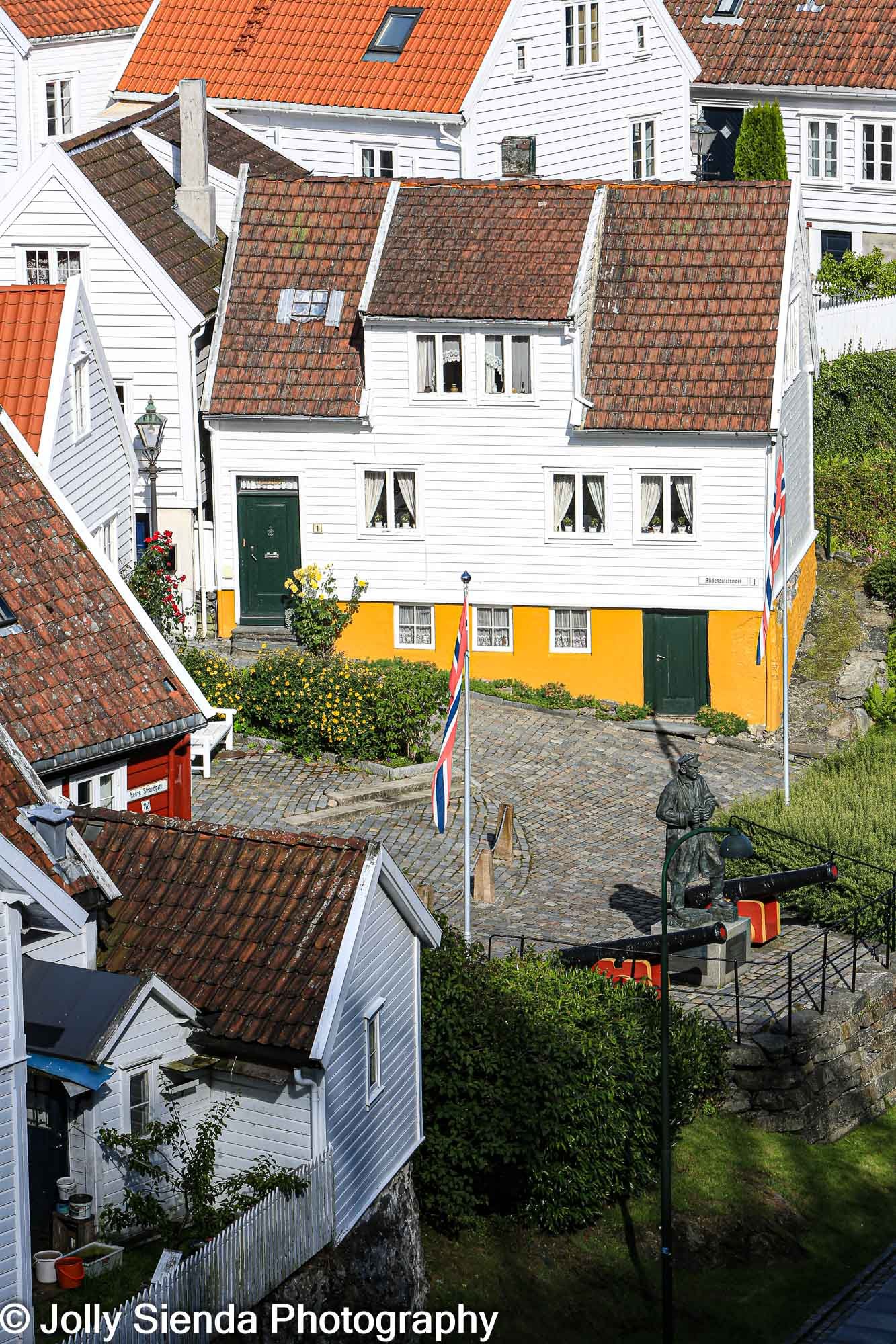 Historic white and yellow houses at Stavenger, Norway and milita