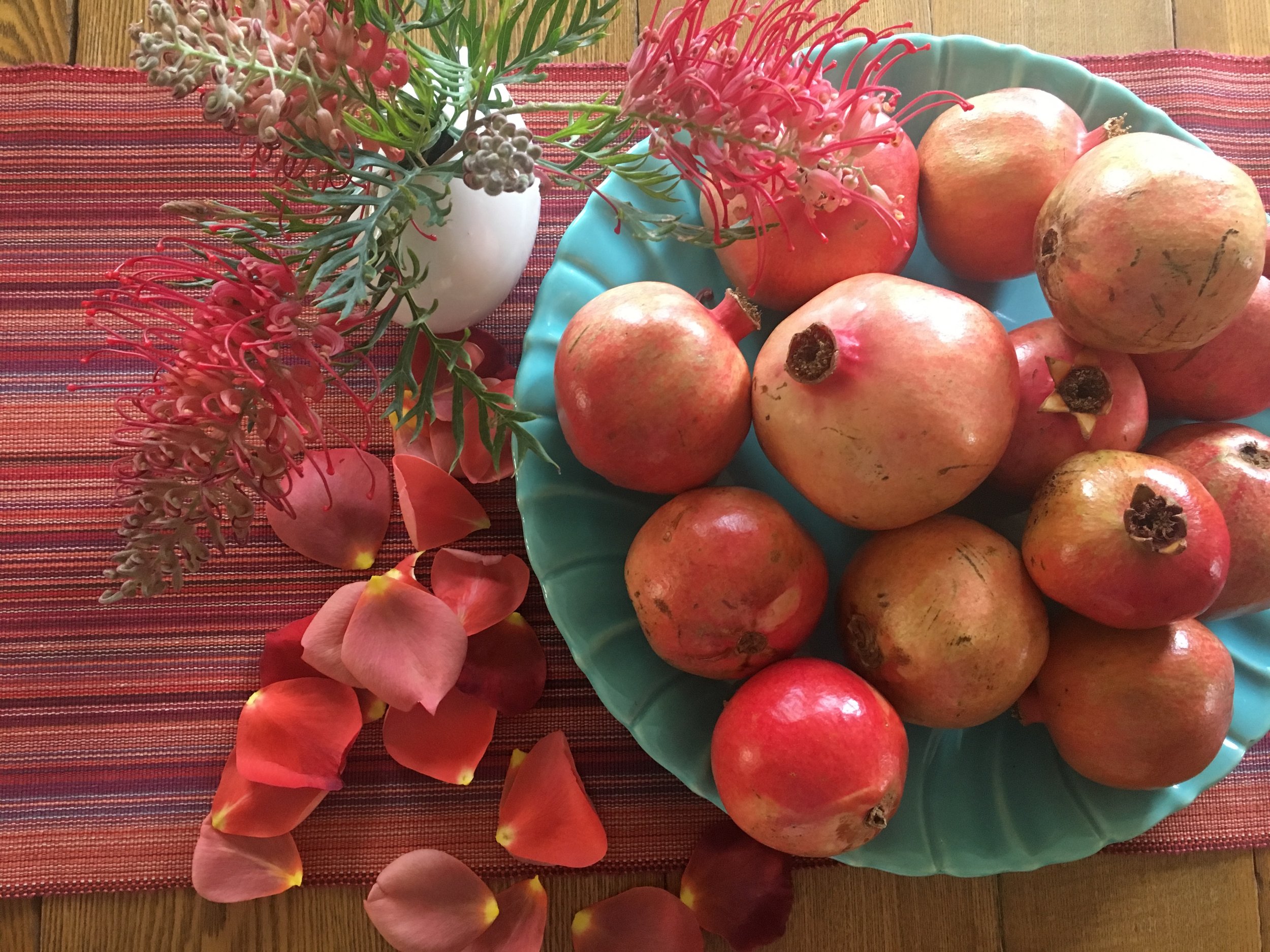 Pomegranates, rose petals and grevillea