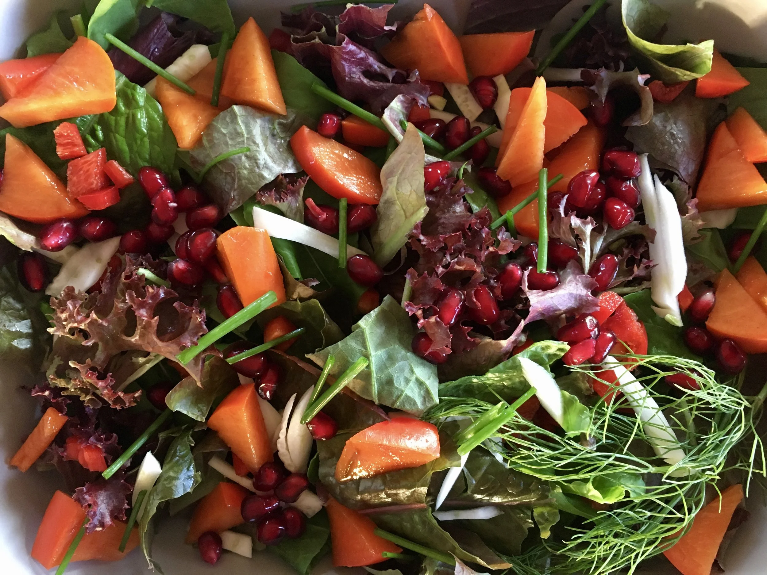 A winter garden salad with fall fruits.