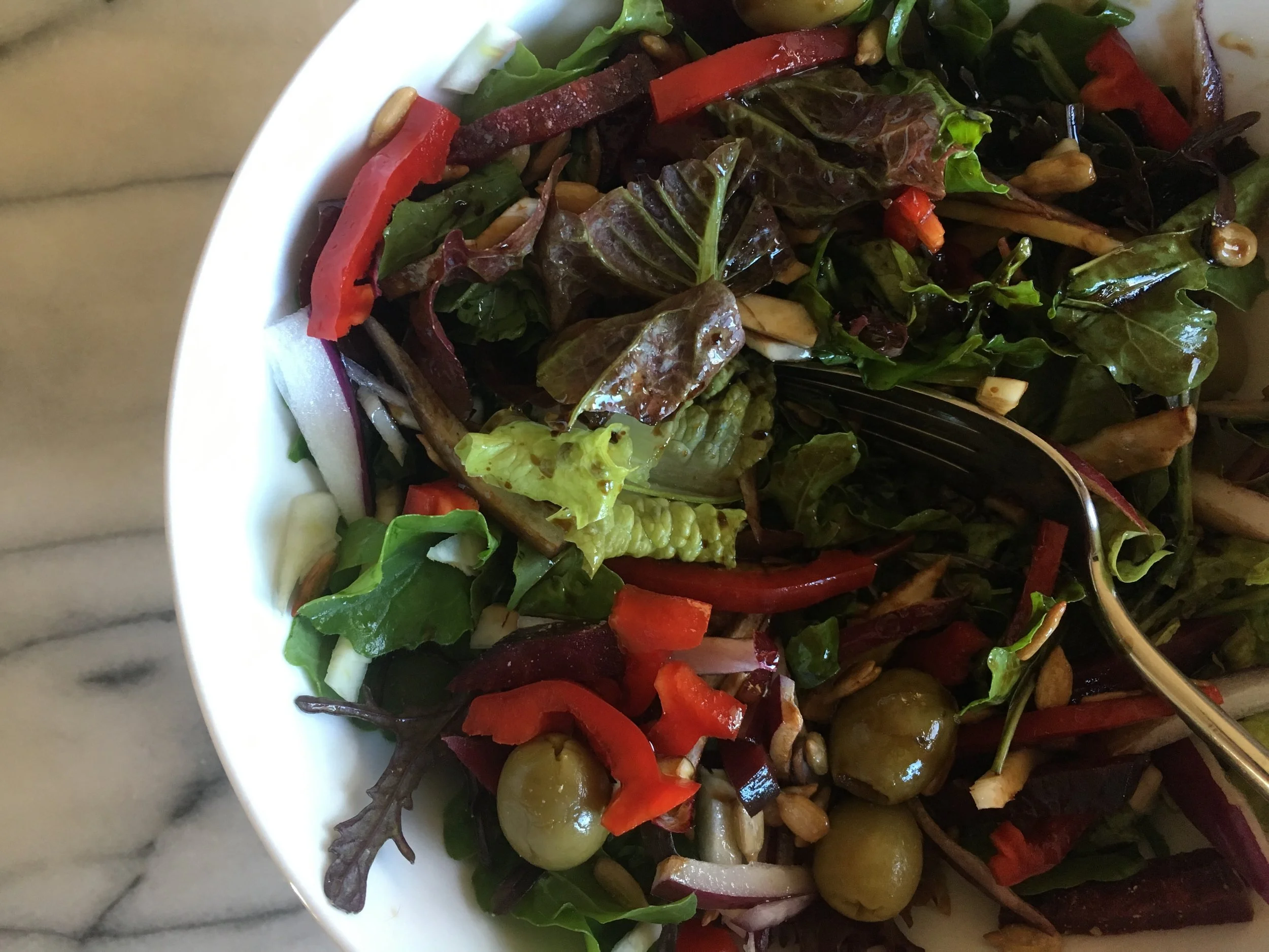 Add red pepper, pickled garden beets, fennel, red onion, sunflower seeds and green olives.