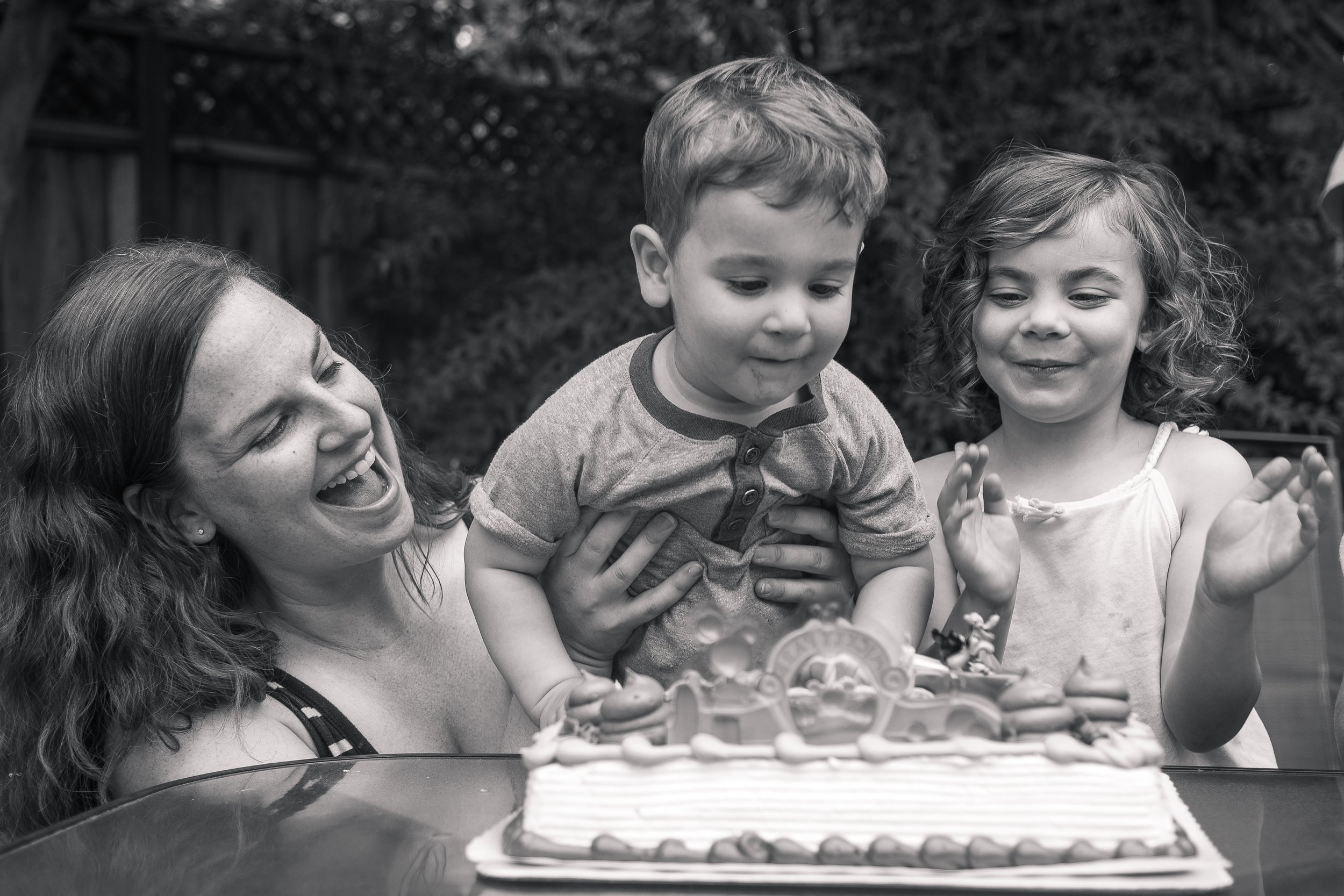 Boy blows out birthday candles at 2nd birthday party in Mountain View
