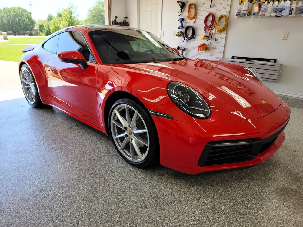 Glossy red Porsche after shine-focused polishing