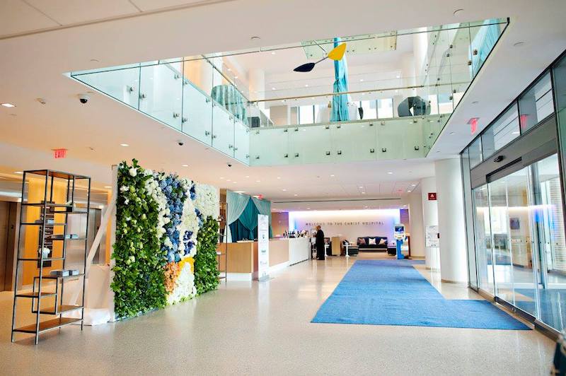 A blue, white, green and yellow floral wall was the perfect welcome for The Christ Hospital's Joint and Spine Center's Grand Opening entrance. 