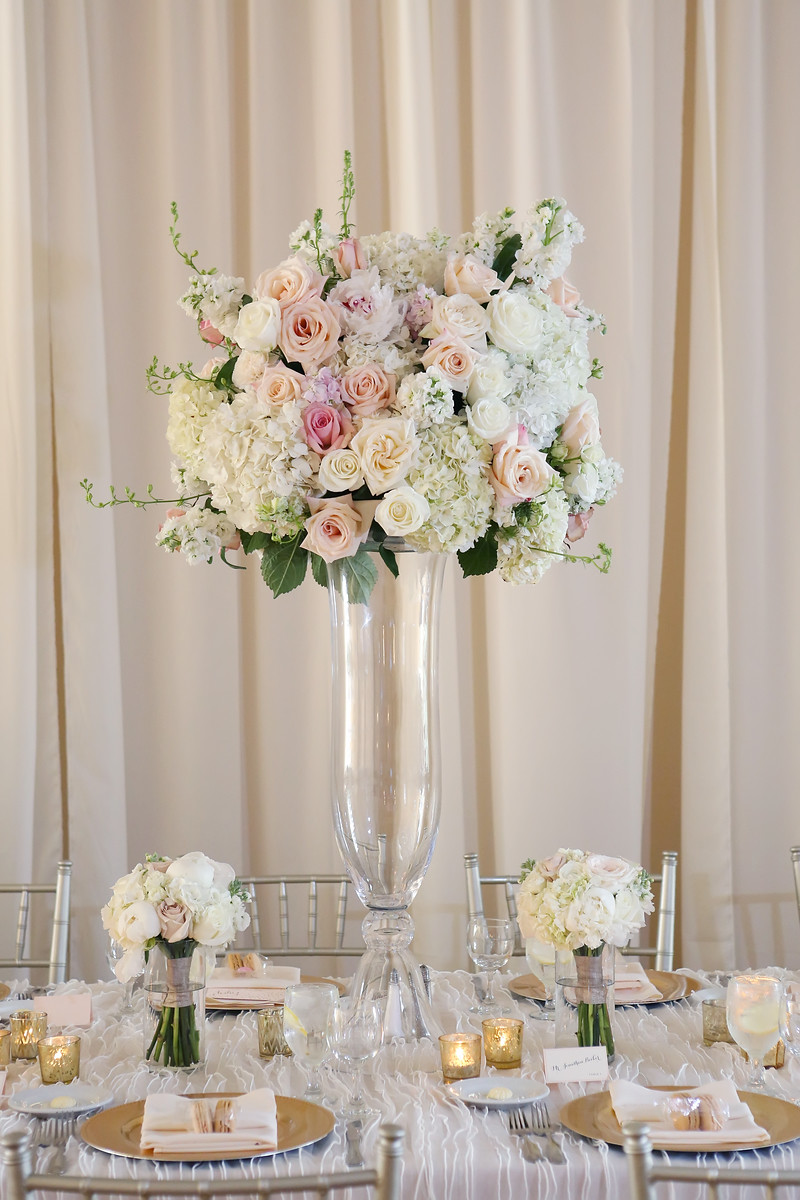 Pink, white, and gold wedding reception in Cincinnati at The Center with florals by Yellow Canary Floral and Event Design. Gold chargers, gold votives, and silver chiavari chairs transformed the reception space.