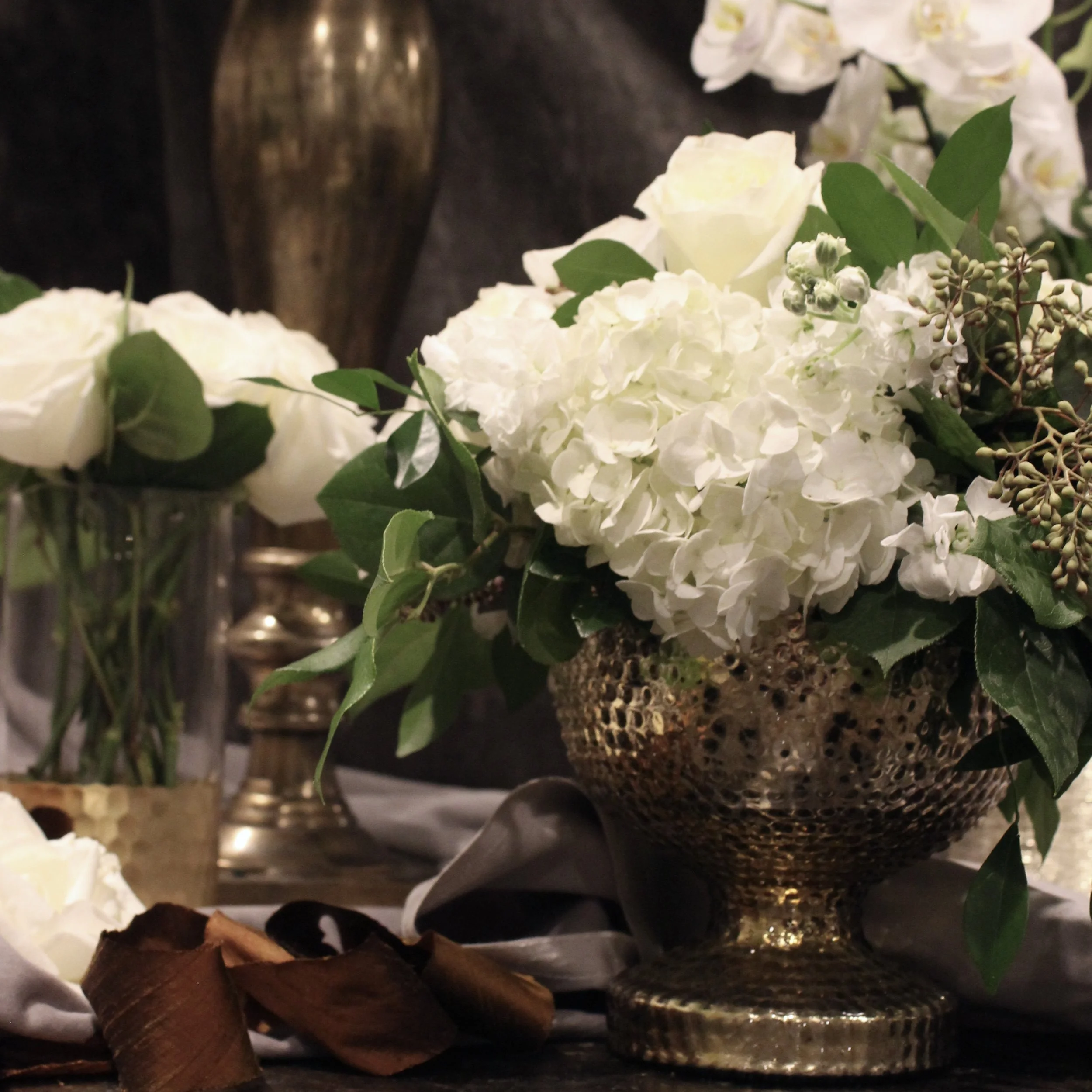 Green and white florals with vintage gold vessels