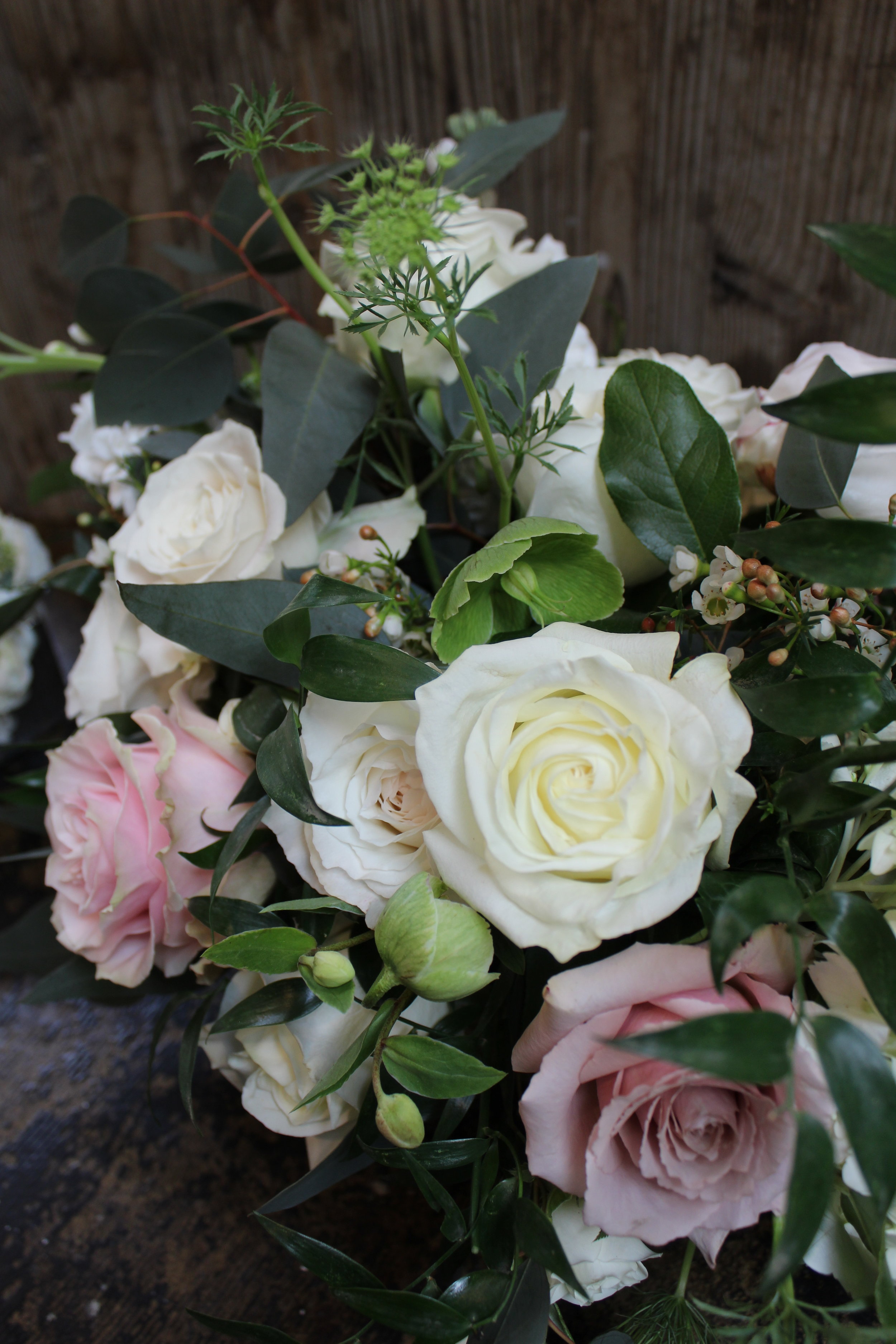 Yellow Canary Floral &amp; Design Studio wedding floral arrangement with white and blush roses and wildflowers.