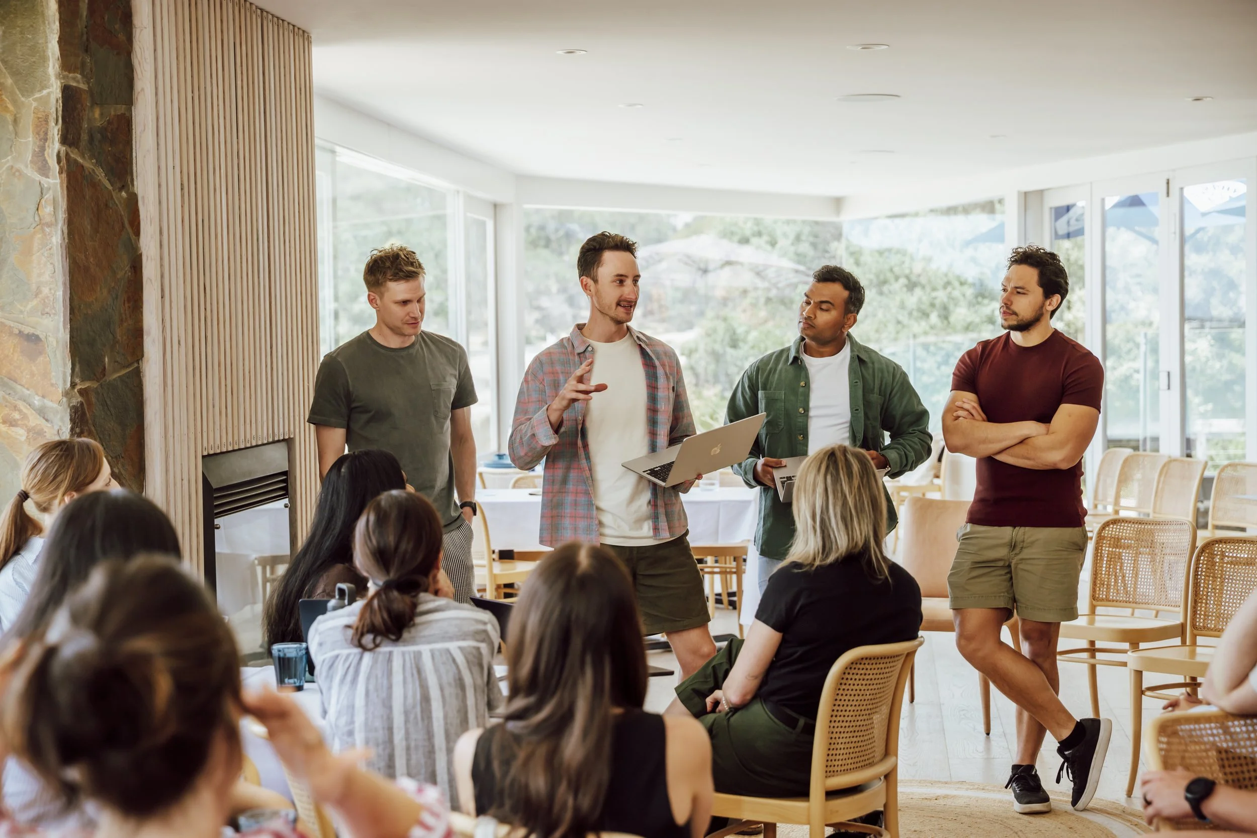 Team members presenting to colleagues with laptops during a strategy day at a Lorne offsite venue