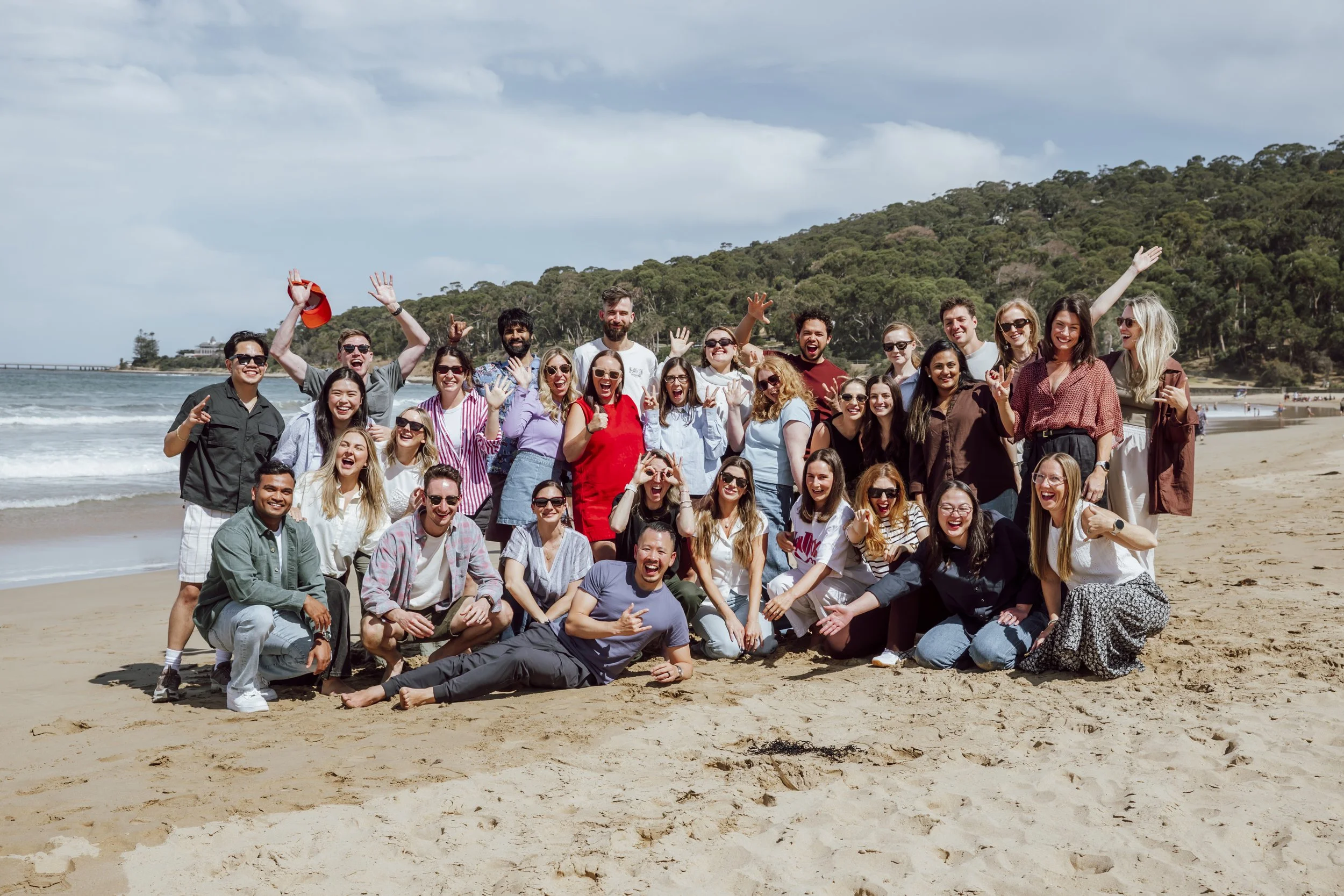 Whole team photo on Lorne beach at the end of a company strategy day