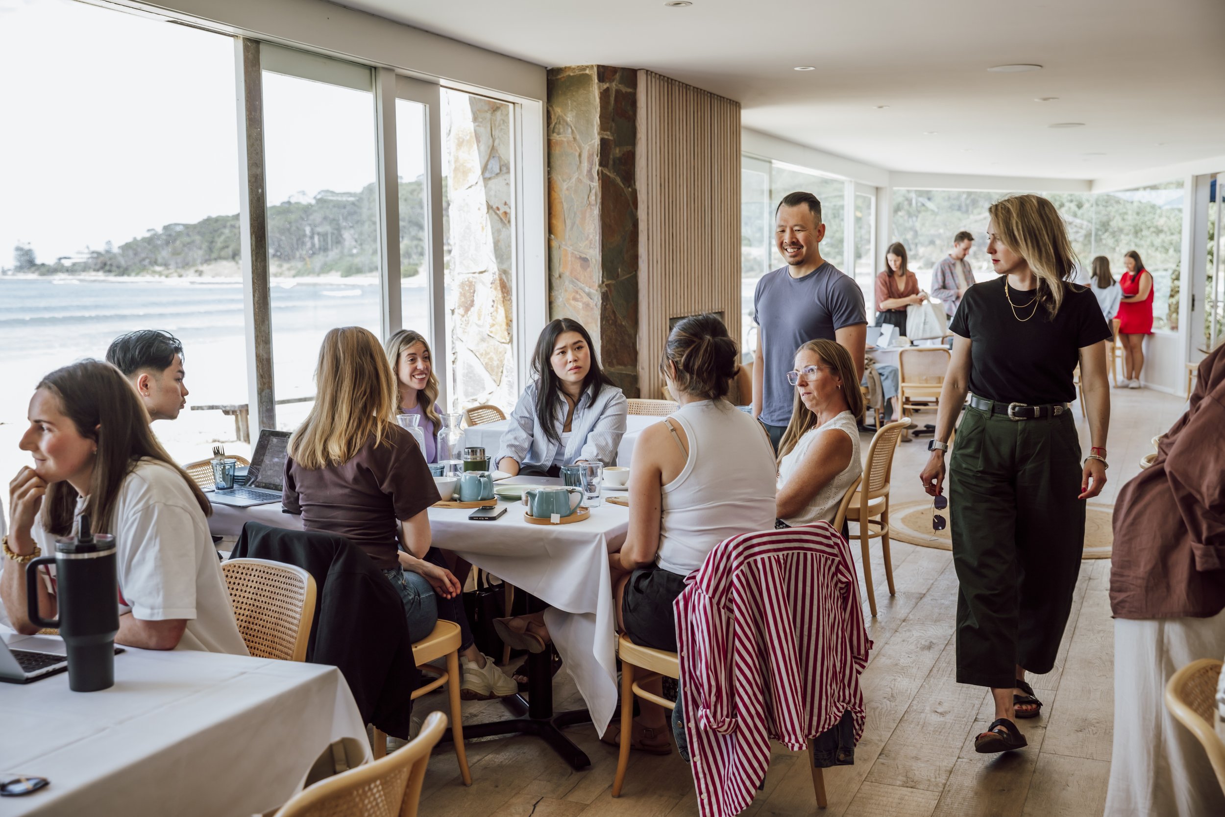Colleagues connecting over breakfast at a beachfront strategy day venue on the Great Ocean Road
