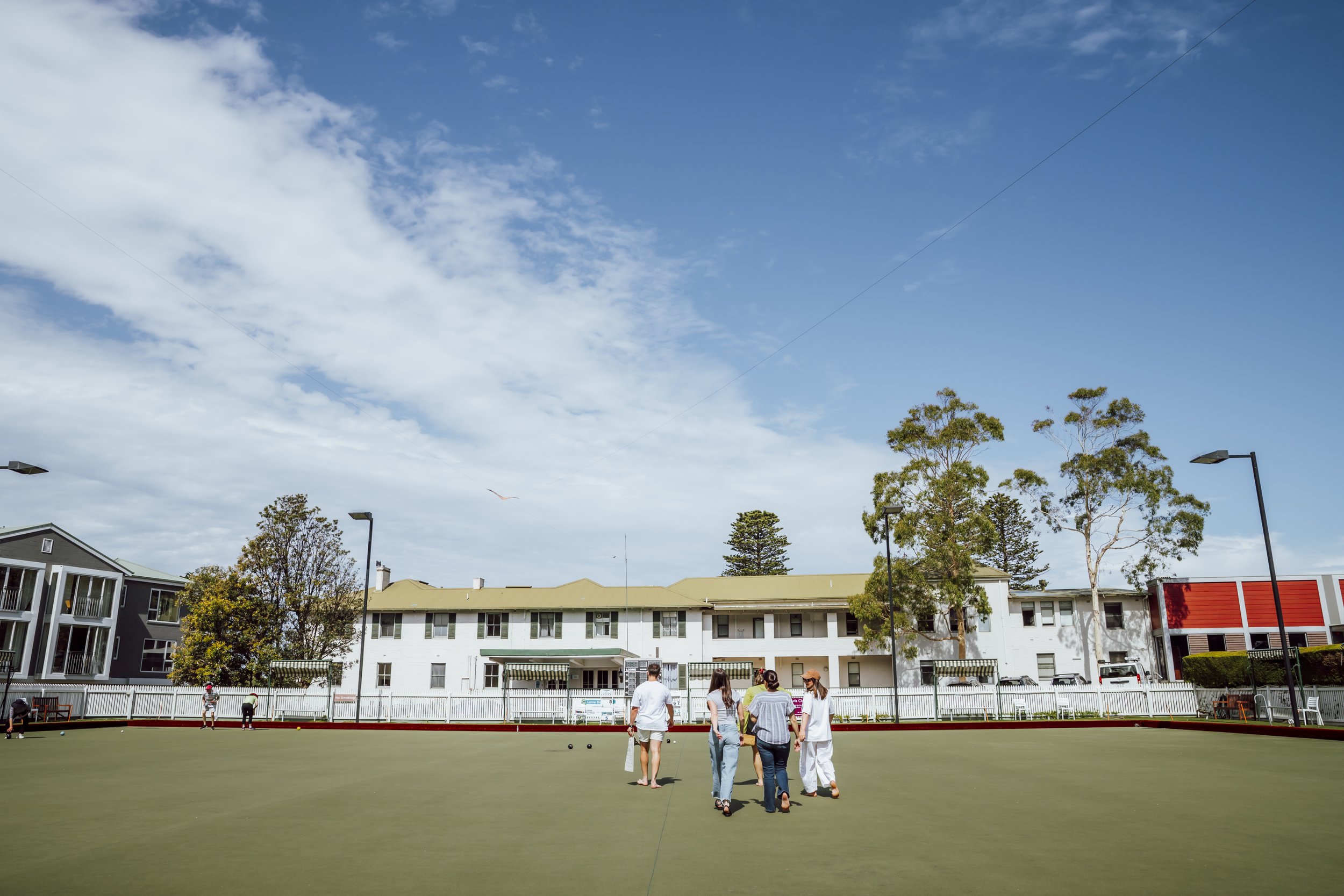 Colleagues playing lawn bowls at a team building day in Lorne