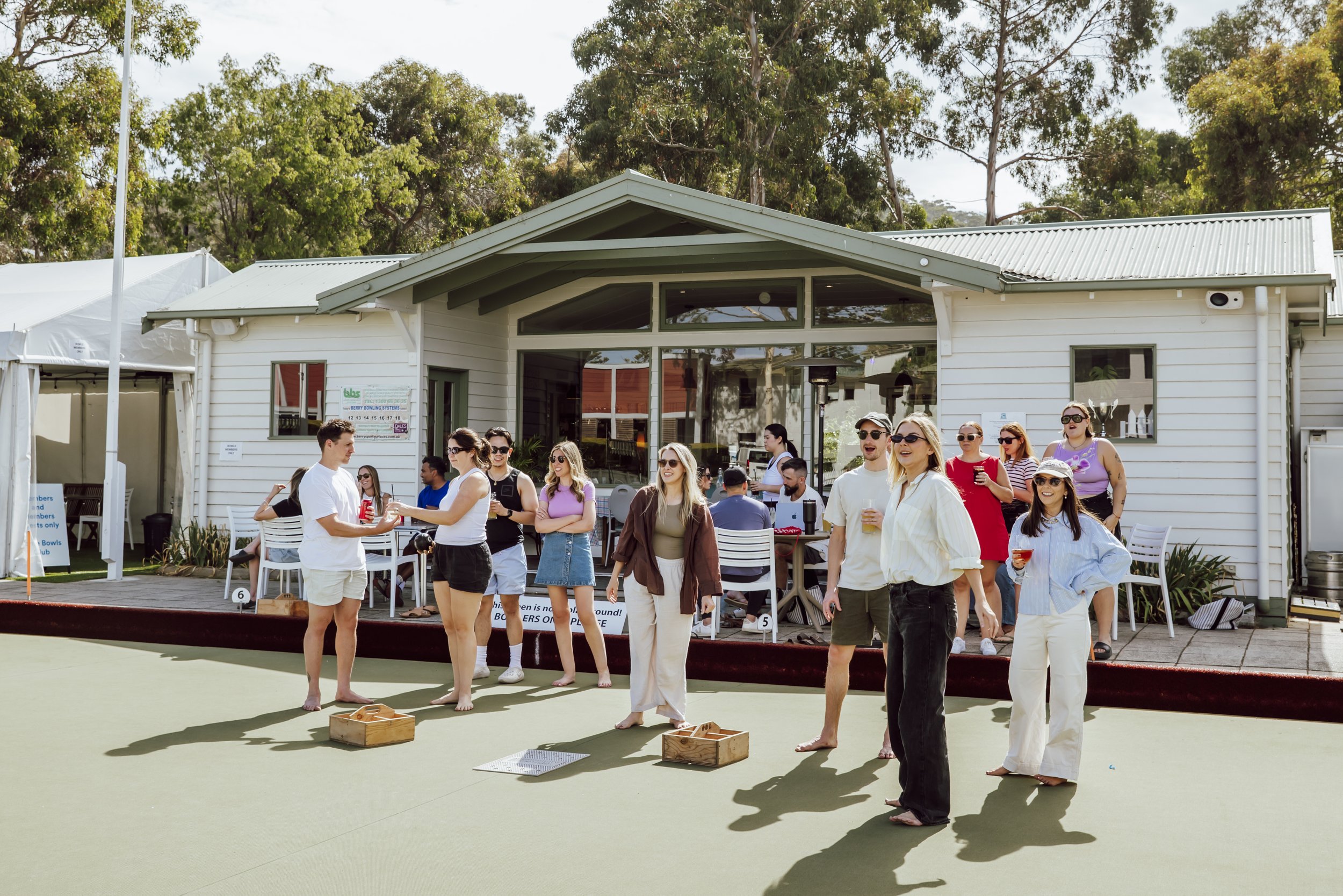 Company team enjoying barefoot bowls and drinks on the green at Lorne Bowls Club