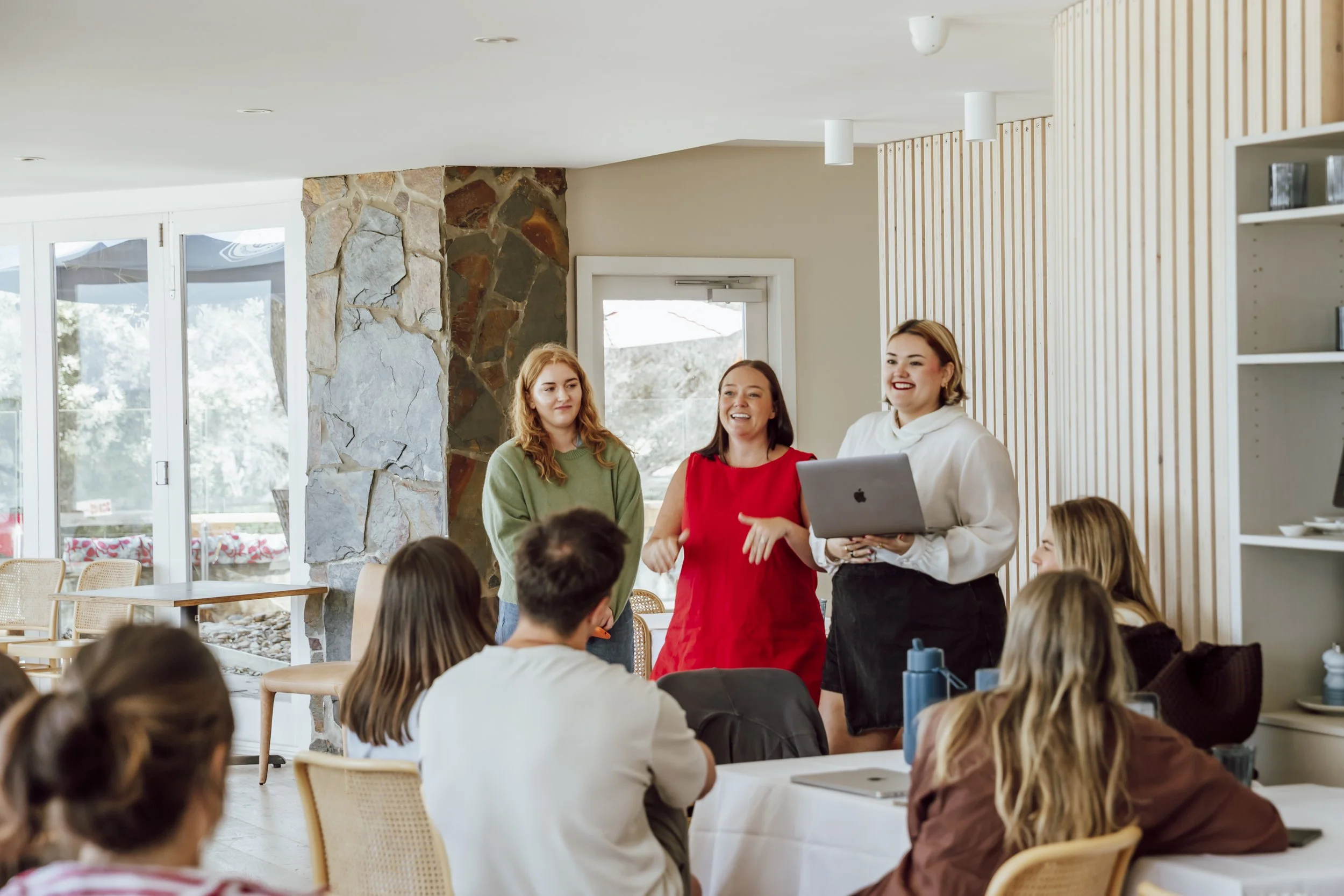 Staff presenting ideas to their team during a company planning day on the Great Ocean Road