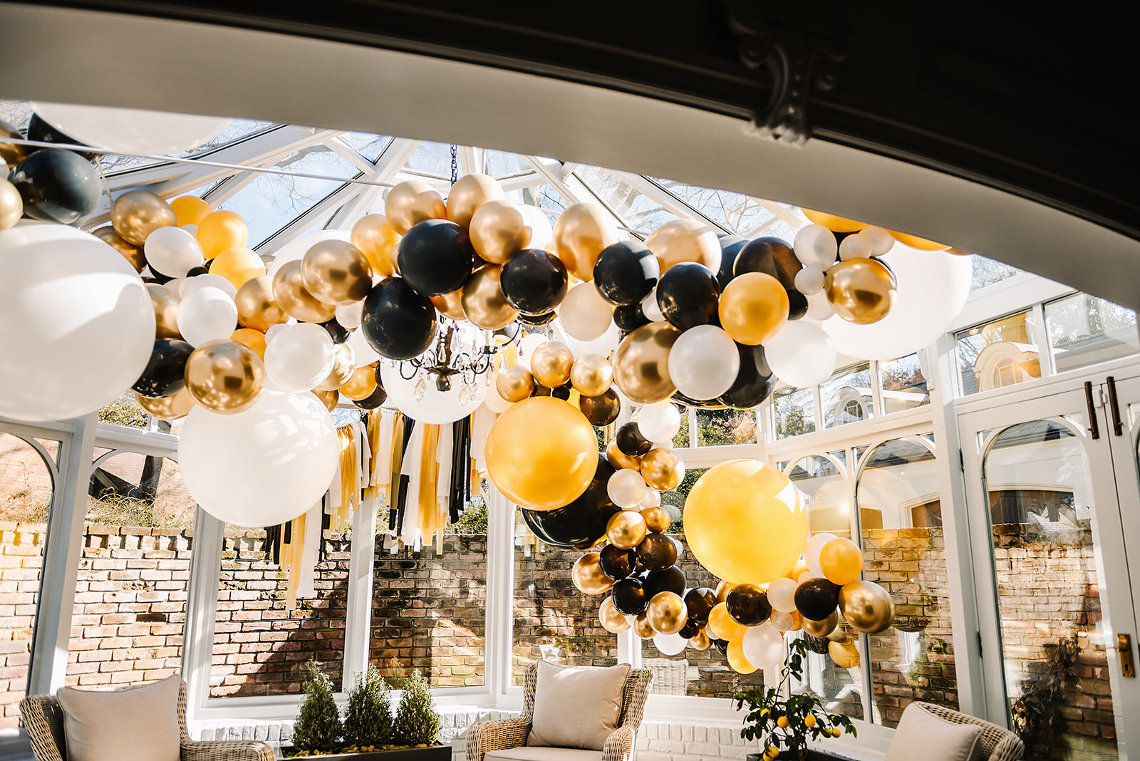 Memphis-event-planner-coroporate-event-planner-the-atrium-memphis-event-venue-shelby-renee-photography-art-deco-decor-custom-event-decor-balloon-arches-garland-black-gold-balloon-wedding-decor