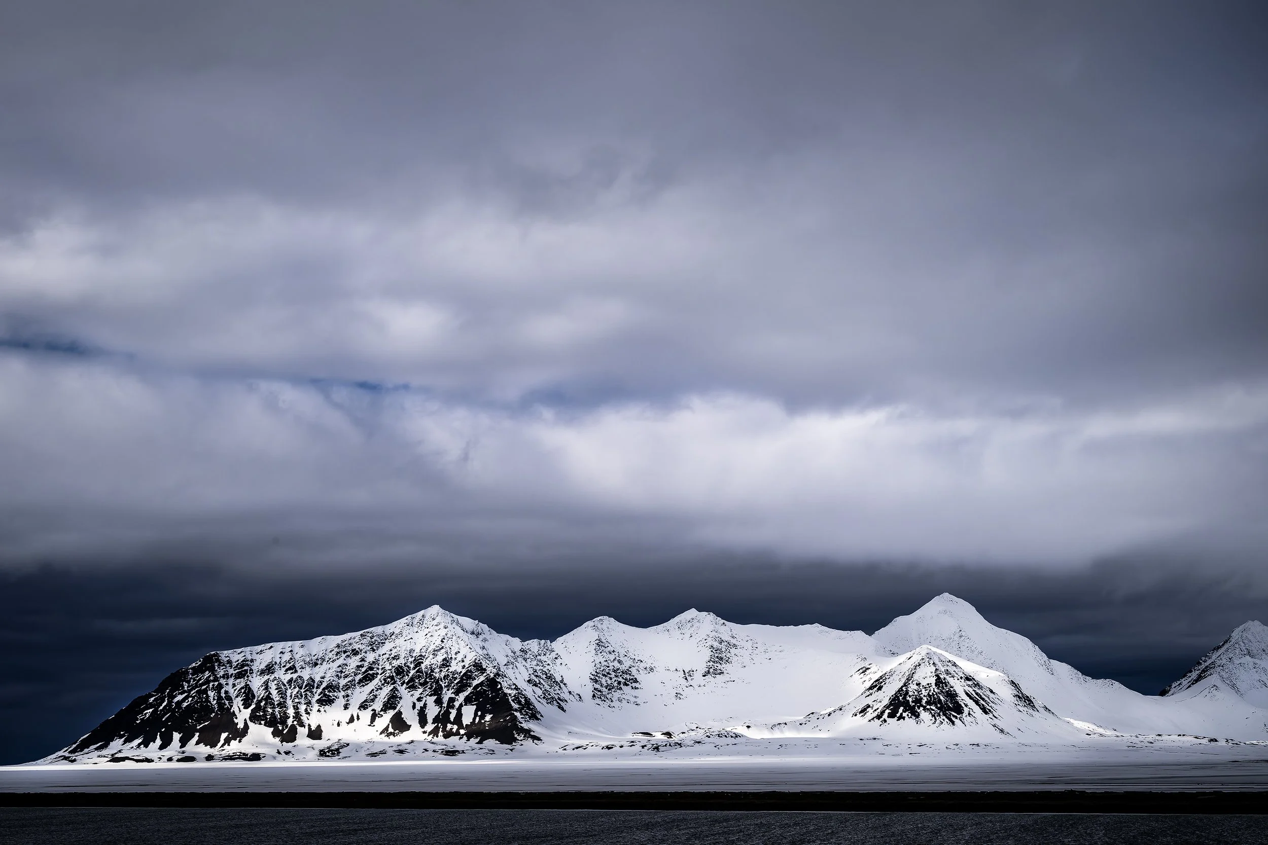 Sunlit Glacial Mountains and Sky, Svalbard 2026