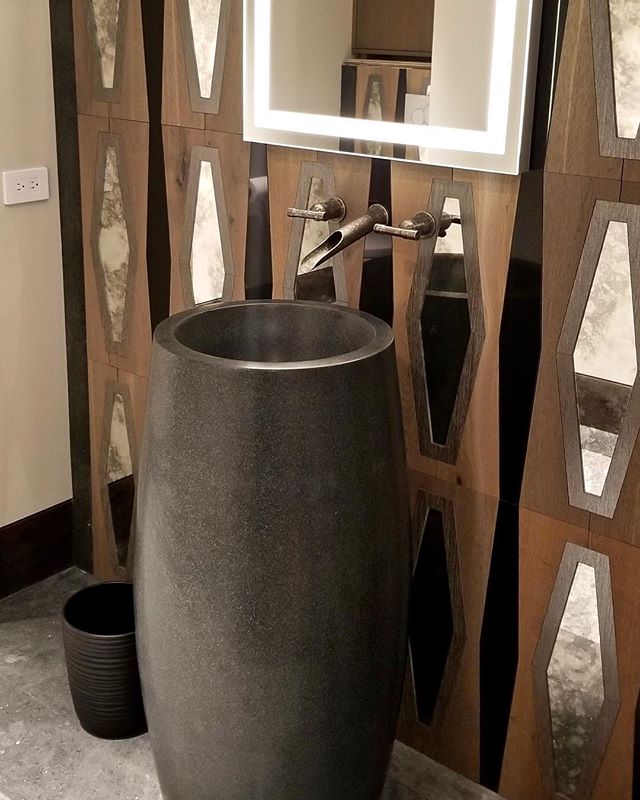 This black marble pedestal sink is accented by contrasting wood tiles inlaid with weathered diamond shaped mirrors and a lighted vanity mirror for a unique look thats both chic and rustic, perfect for our modern mountain home. #solannadesign